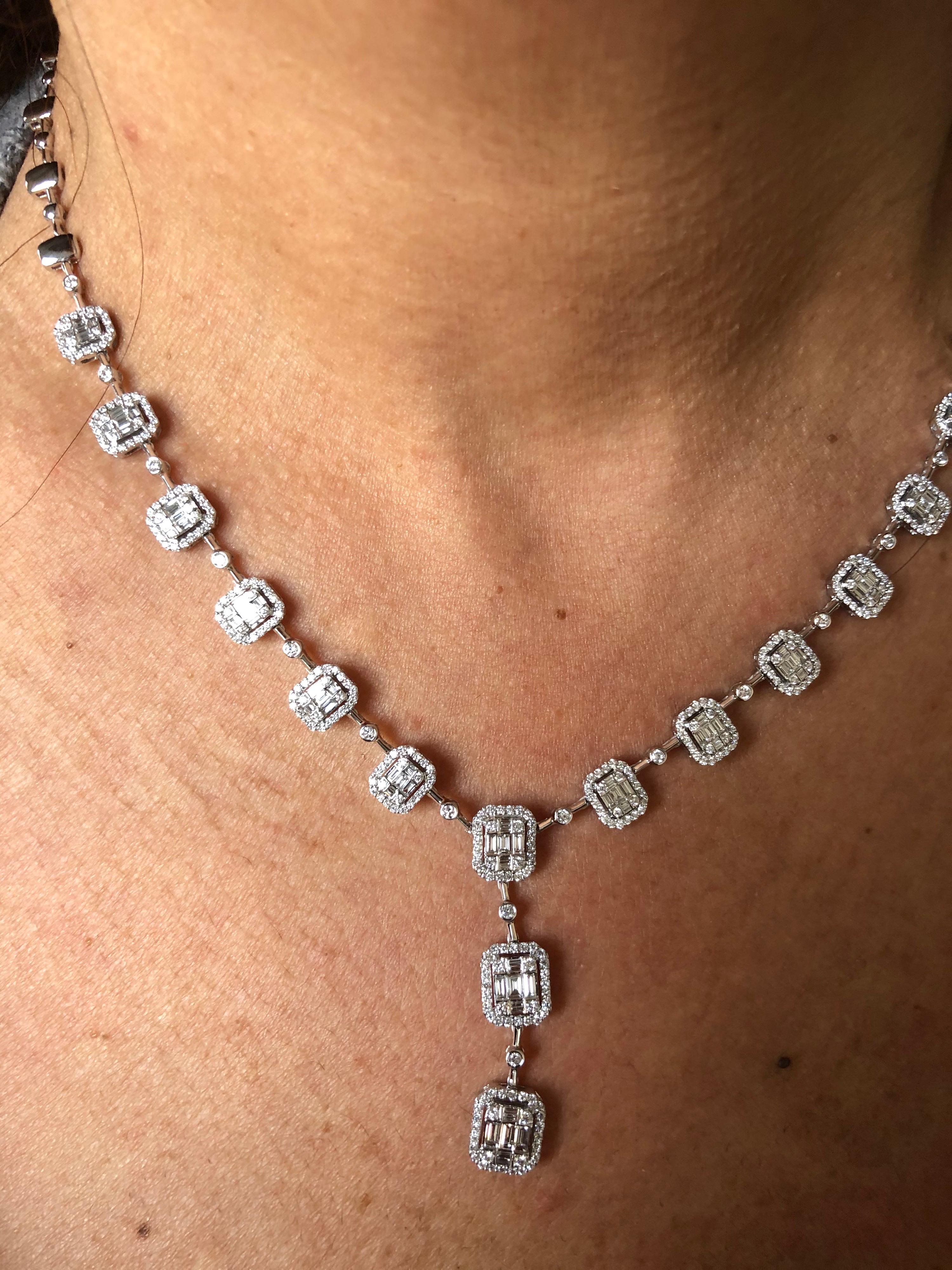 Diamond necklace set in 18K white gold with a cluster of baguette and round diamonds to create the illusion of a single emerald cut. The total carat weight of the necklace is 6.57 carats. The necklace is 17 inch at length. The color of the stones