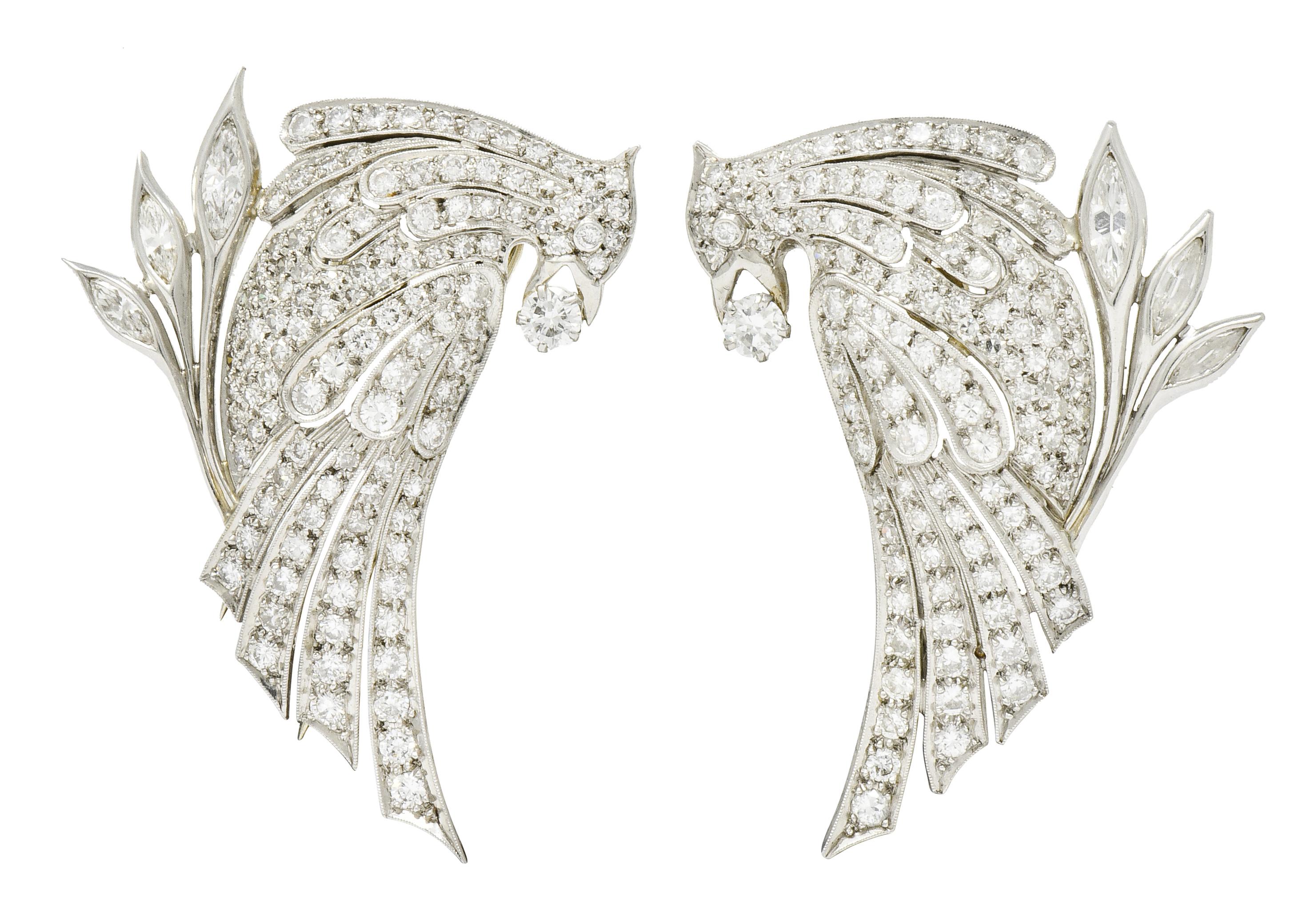 Clip style brooches designed as a pair of stylized quail birds clutching a round brilliant cut diamond in its beak weighing in total approximately 0.26 carat; G/H color with VS clarity

With sweeping geometric feather channels and olive branches