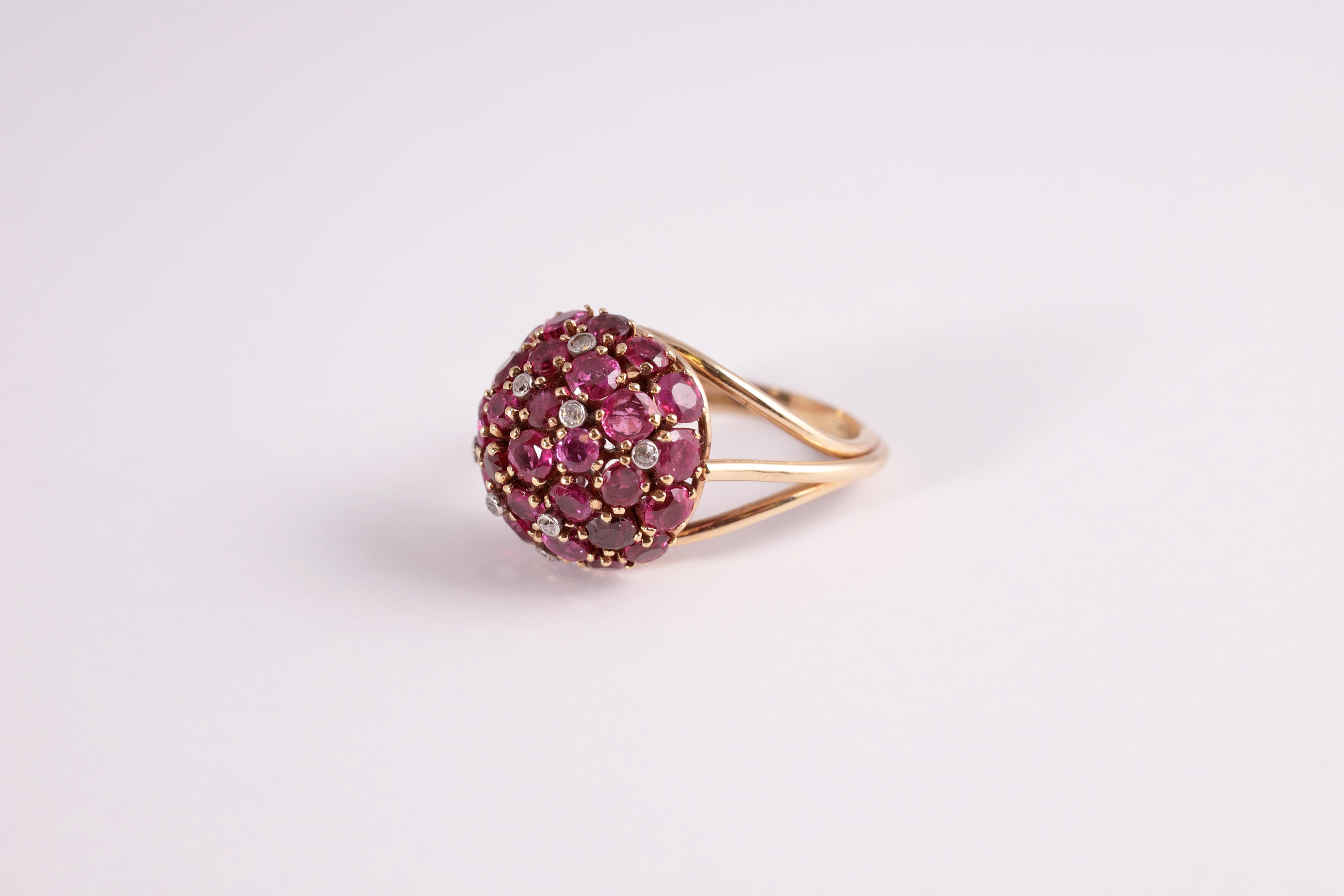 6.50 carats of rubies and .08 carats of diamonds are pave set to create this stunning round dome ring.  The stones are set in 14 karat yellow gold.  Size 8 1/4.