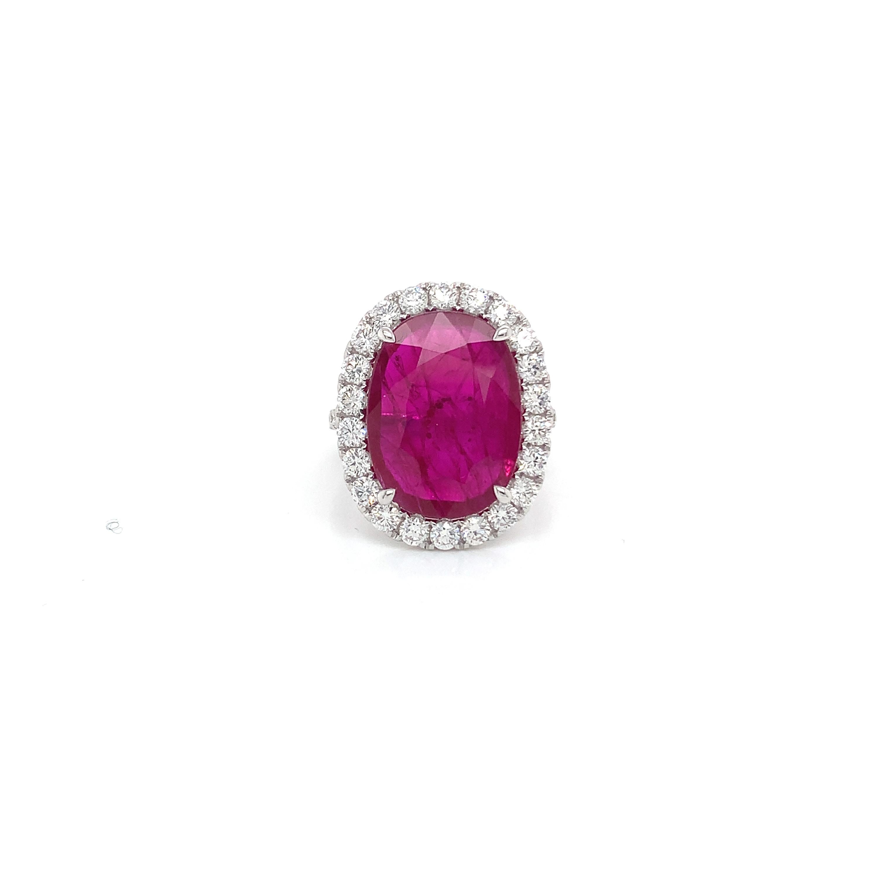 Oval Ruby weighing 6.50 cts
Measuring (16.95x12.70x2.40) mm
34 round diamonds weighing 1.44 cts
Set in 18k white gold ring