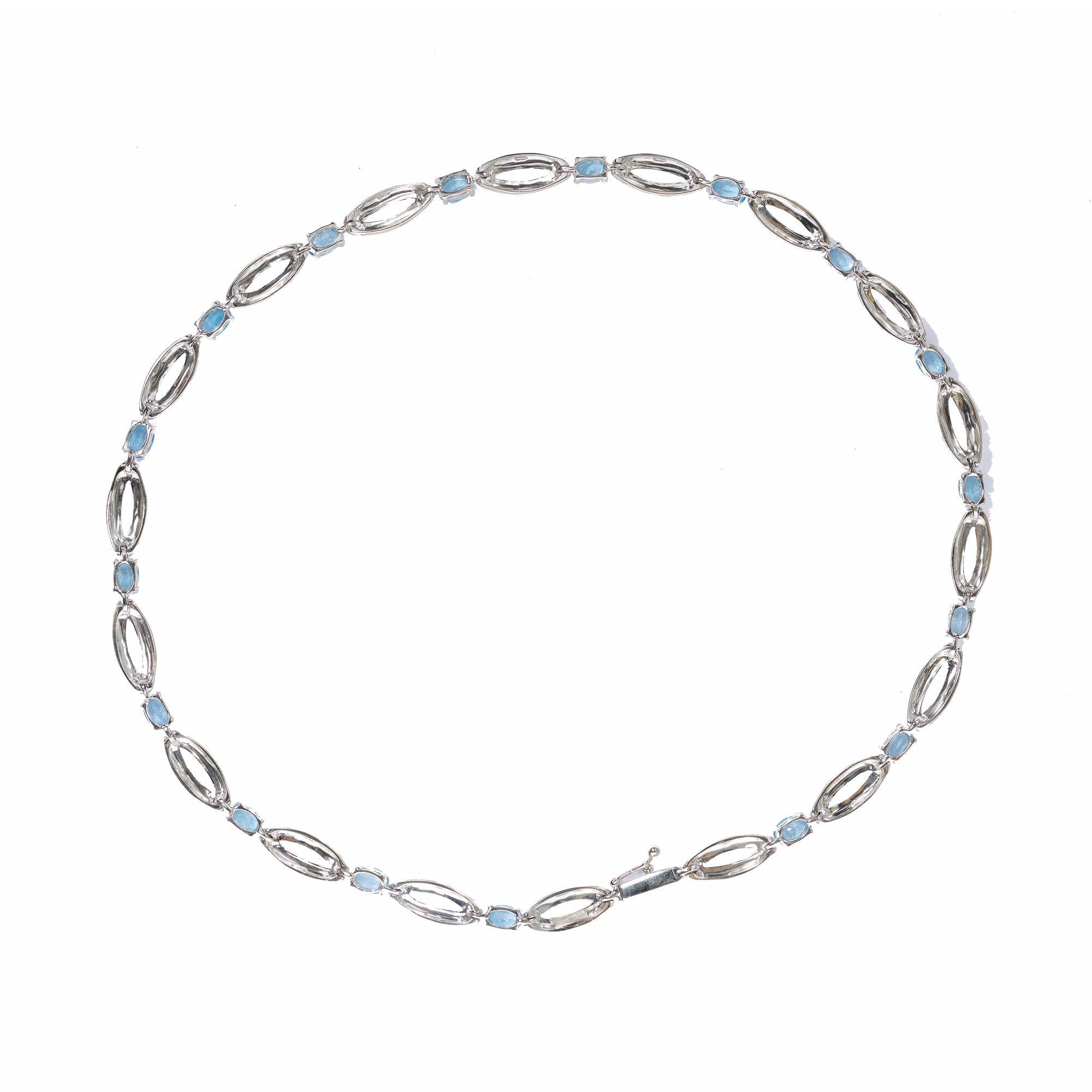 Oval blue topaz necklace. 14k White gold links with oval topaz separators. 

17 oval blue topaz, Approximate 6.50cts
Chain: 17 Inches
14k white gold 
Stamped: 14k ITALY
27.8 grams
Width: 6.2mm 
Thickness/Depth: 4.6mm
