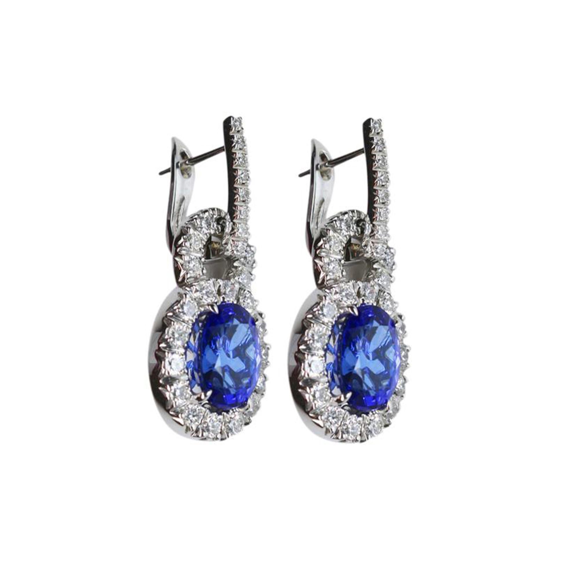Beautiful, Elegant & finely detailed Drop Earrings, each Earring set with a Vivid Blue Tanzanite gemstone, clarity: I/F; surrounded by micro-set round brilliant cut Diamonds; approx. total weight of the 2 Tanzanite: 6.50 Carats; approx. total weight