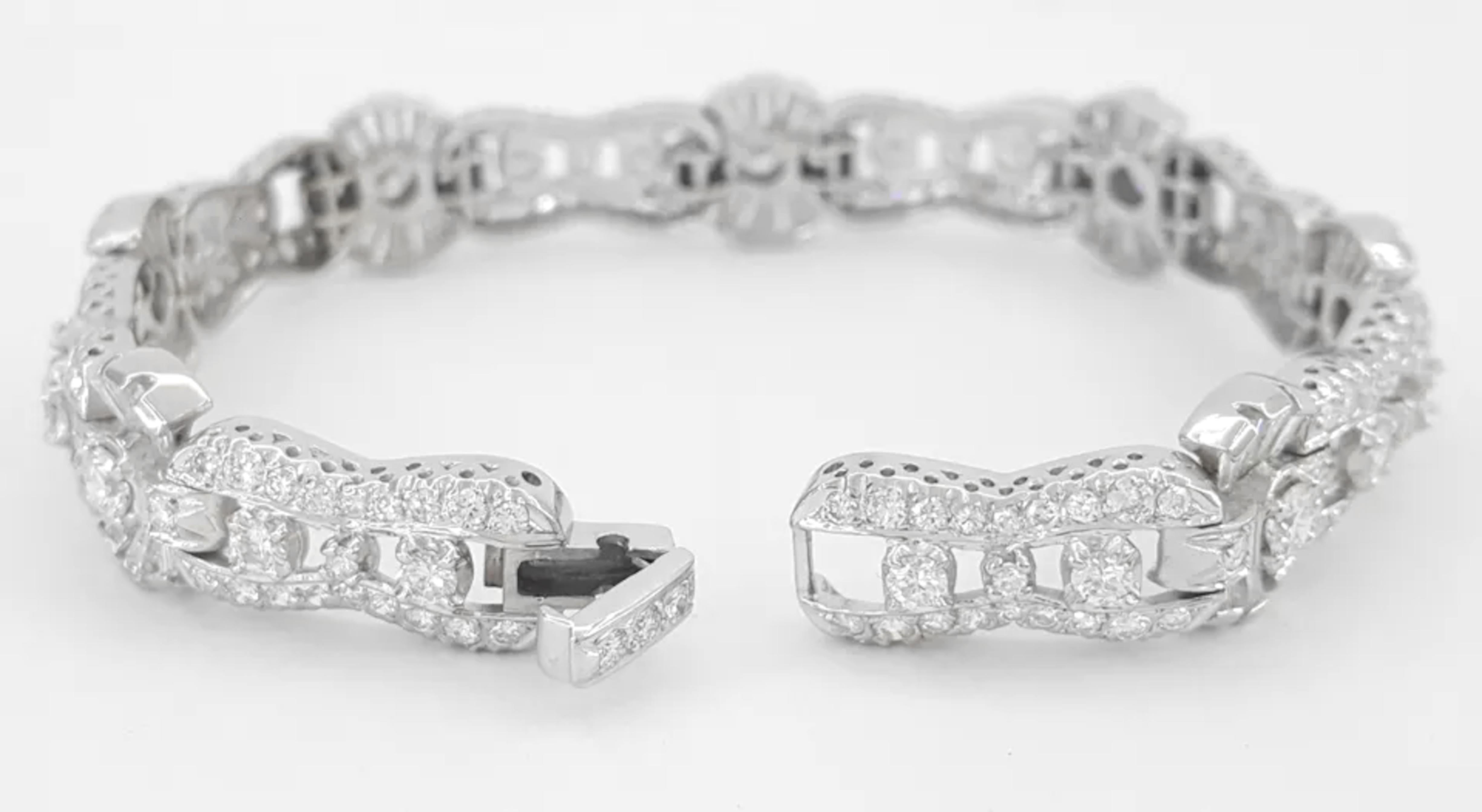 diamond tennis bracelet is an elegant piece of jewelry featuring both round and tapered baguette cut diamonds. It has a total carat weight of approximately 6.5 carats, showcasing high-quality diamonds with E-H color grades and VS-SI clarity, meaning