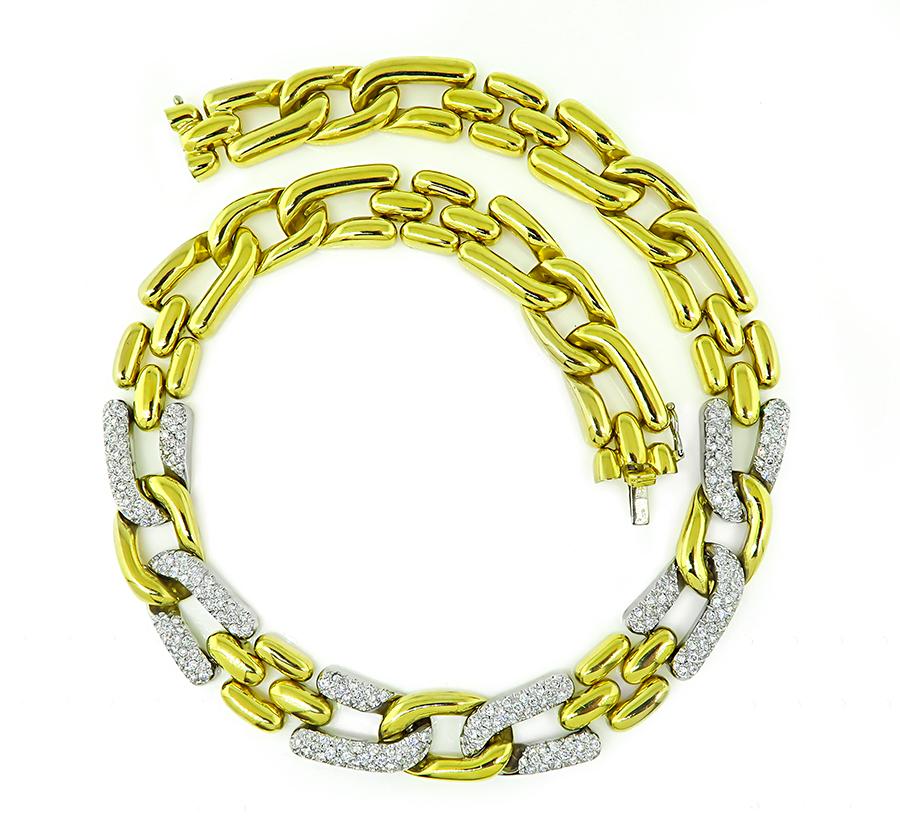 This is an elegant two tone 18k yellow and white gold chain necklace. The necklace is set with sparkling round cut diamonds that weigh approximately 6.50ct. The color of these diamonds is G with VS clarity. The necklace measures 17 1/2 inches in