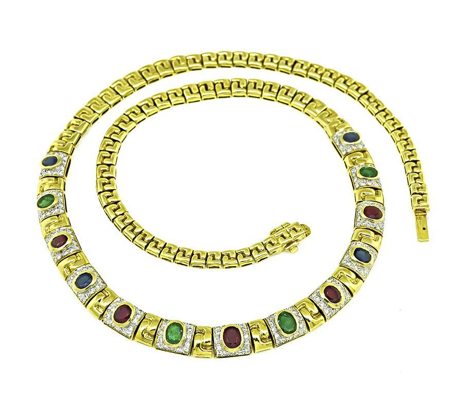 This is gorgeous 18k yellow and white gold necklace. The necklace is set with lovely oval cut sapphires, rubies and emeralds that weigh approximately 6.50ct. The precious stones are accentuated by sparkling round cut diamond accents. The necklace