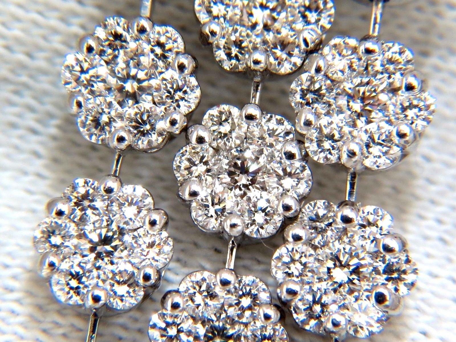 5 Tier & floating cluster drops.

Wide Chandelier earrings.

6.50cts of natural round diamonds: 

Rounds, Full Cut brilliants.

G-color, Vs-2 clarity.

18kt. white gold

19 grams.

Earrings measure: 2 inch long

.6 inch wide

Cluster top: .41