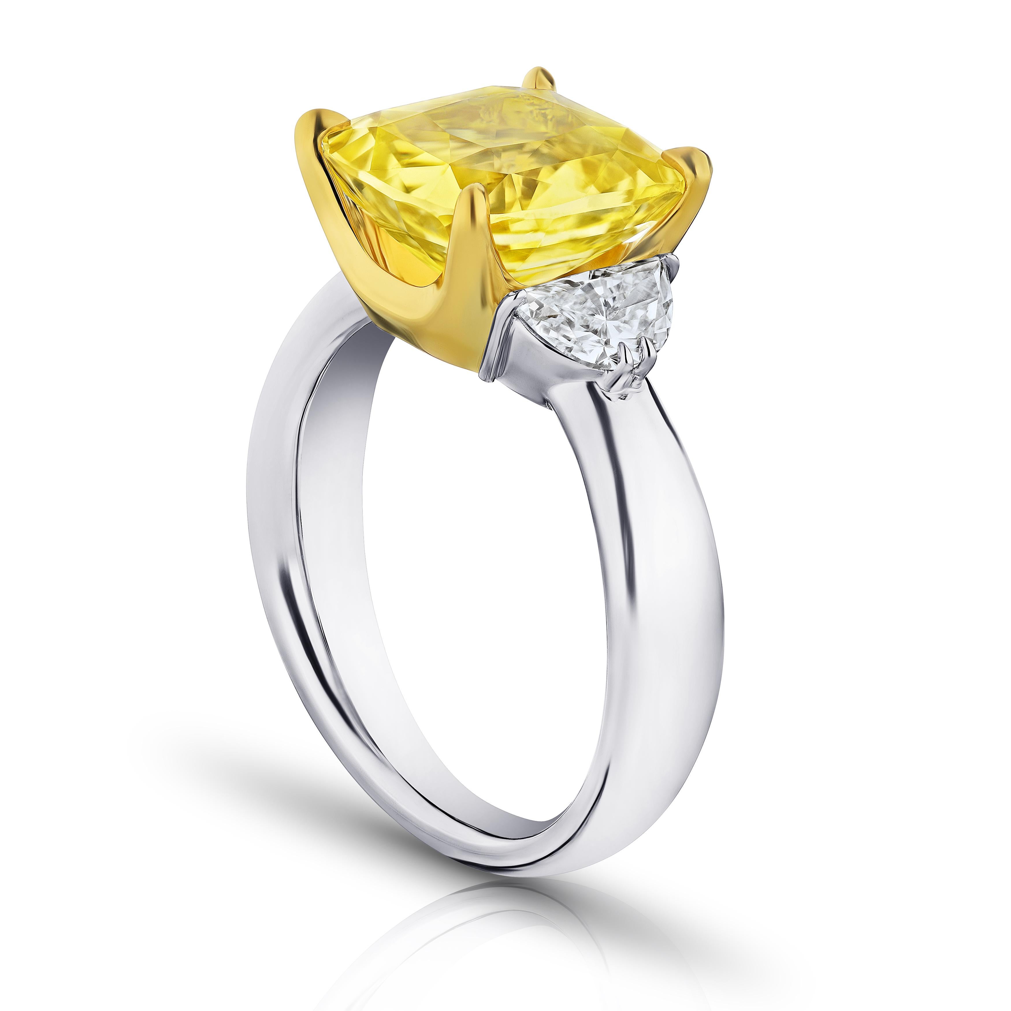 6.51 carat cushion yellow sapphire with half moon diamonds .80 carats set in a platinum with 18k yellow gold ring. Ring is currently a size 7. Resizing to your finger size is included.
