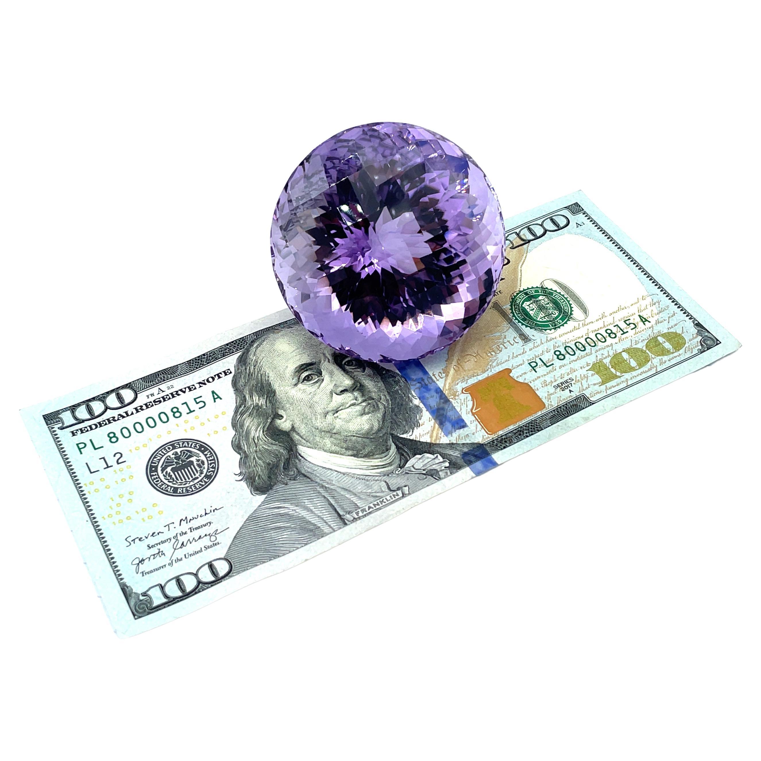 This is a perfect gift for the person who has everything! This stunningly beautiful, round amethyst gemstone weighs a whopping 651 carats and would make a breathtakingly impressive desk accessory. The top of the gemstone, aka the 
