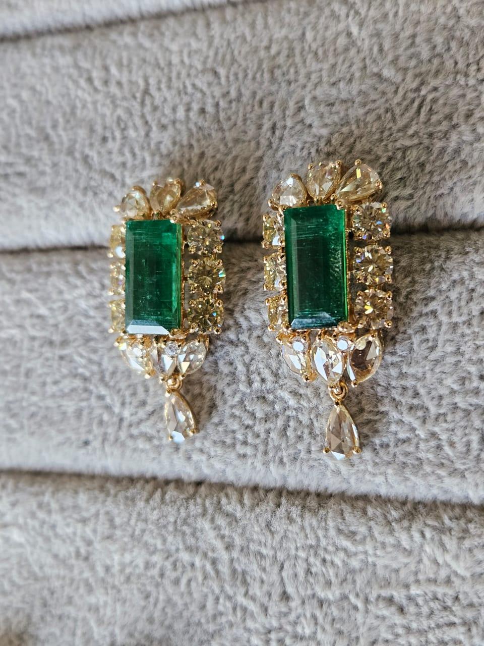 A very gorgeous and beautiful, Emerald Dangle Earrings set in 18K Yellow Gold & natural Diamonds. The weight of the Emeralds is 6.51 carats. The Emeralds are completely natural, without any treatment and are of Zambian origin. The combined Diamonds