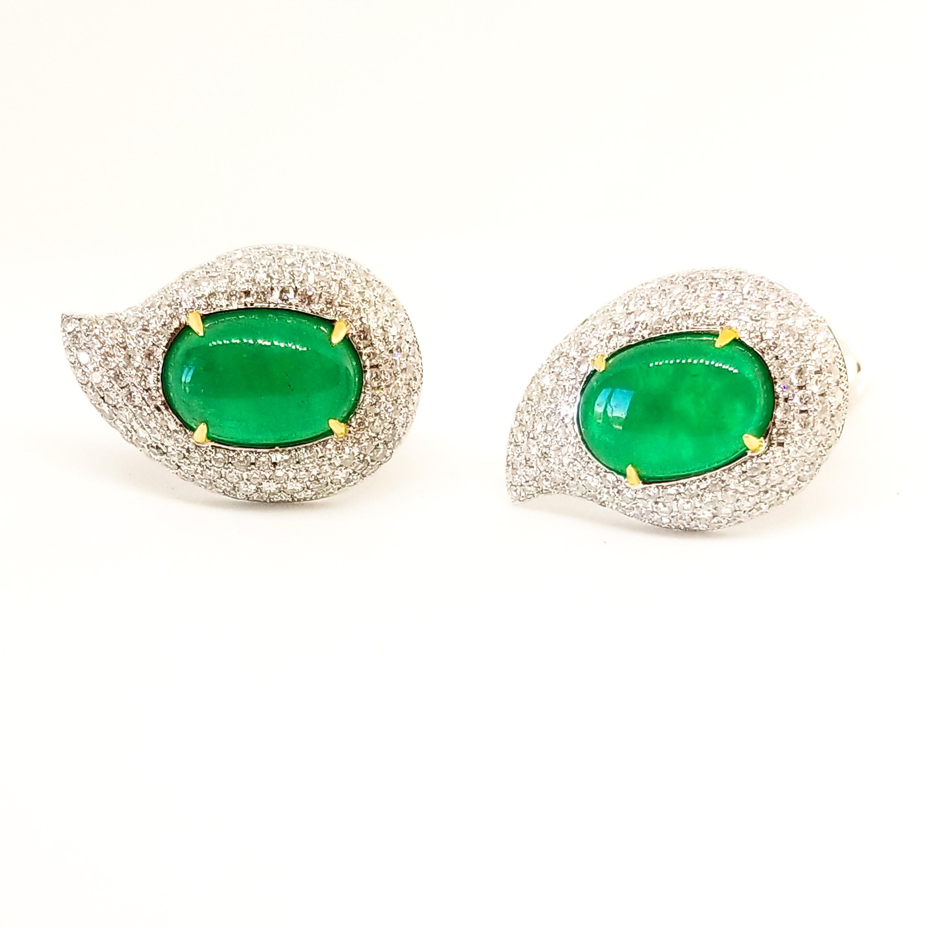 This Brilliant Green pair of on the earlobe, Elegantly Curved Droplet Earrings feature a pair of Oval Cabochon Emeralds of rich Grass Green Hue and a combined weight of 6.52 Carats. The Gem Quality, Genuine Emeralds measure 12 x 8mm each and are