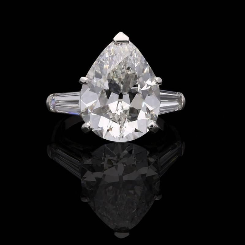 A wonderful diamond ring circa 1960s, centred on a stunning old-cut pear-shape diamond weighing 6.53 carats and of G colour and VVS2 clarity claw set between elegant tapered baguette diamond shoulders, all mounted in platinum.

6.53 carat G VVS2