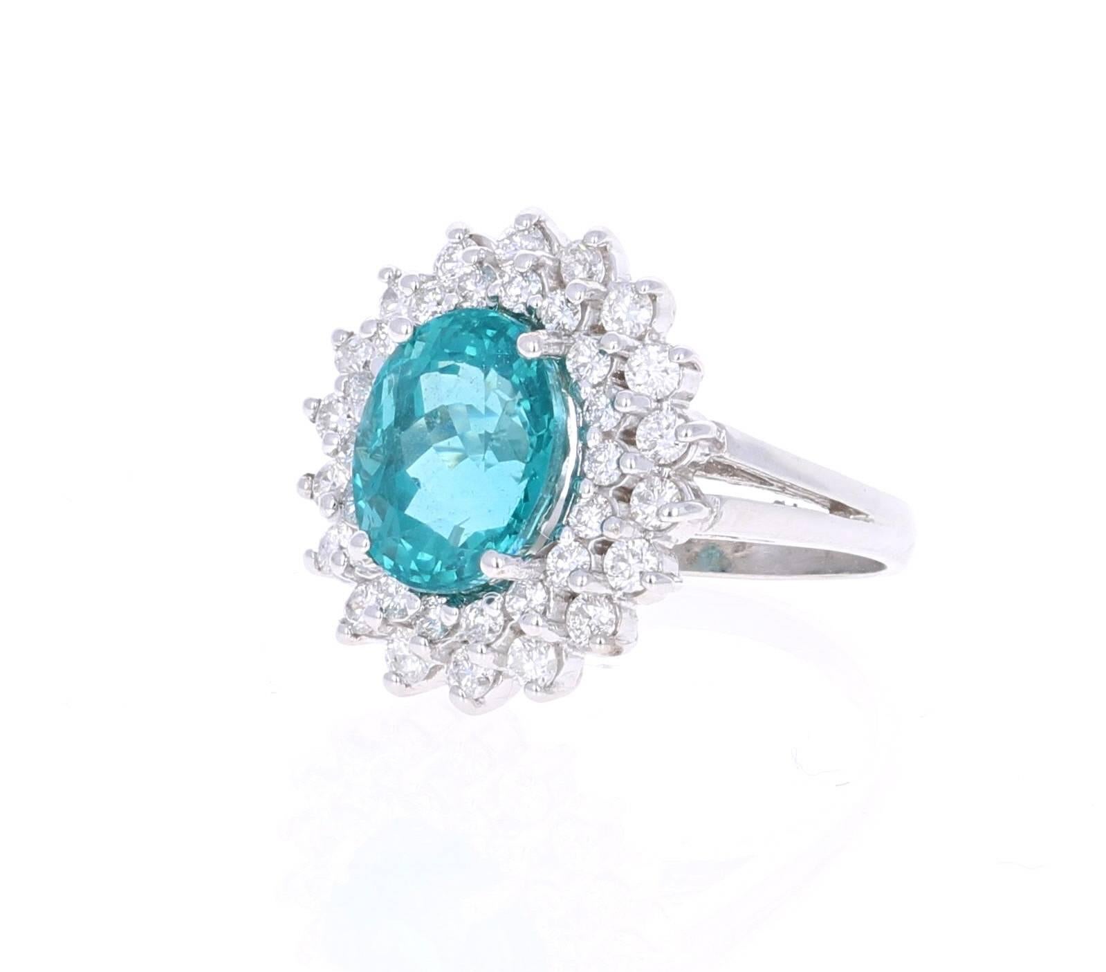 This stunning Apatite and Diamond Ring can easily transform into a unique and classy engagement ring for your special someone!  The ring has a 5.39 Carat Oval Cut Apatite set in the center of the ring surrounded by 36 Round Cut Diamonds that weigh