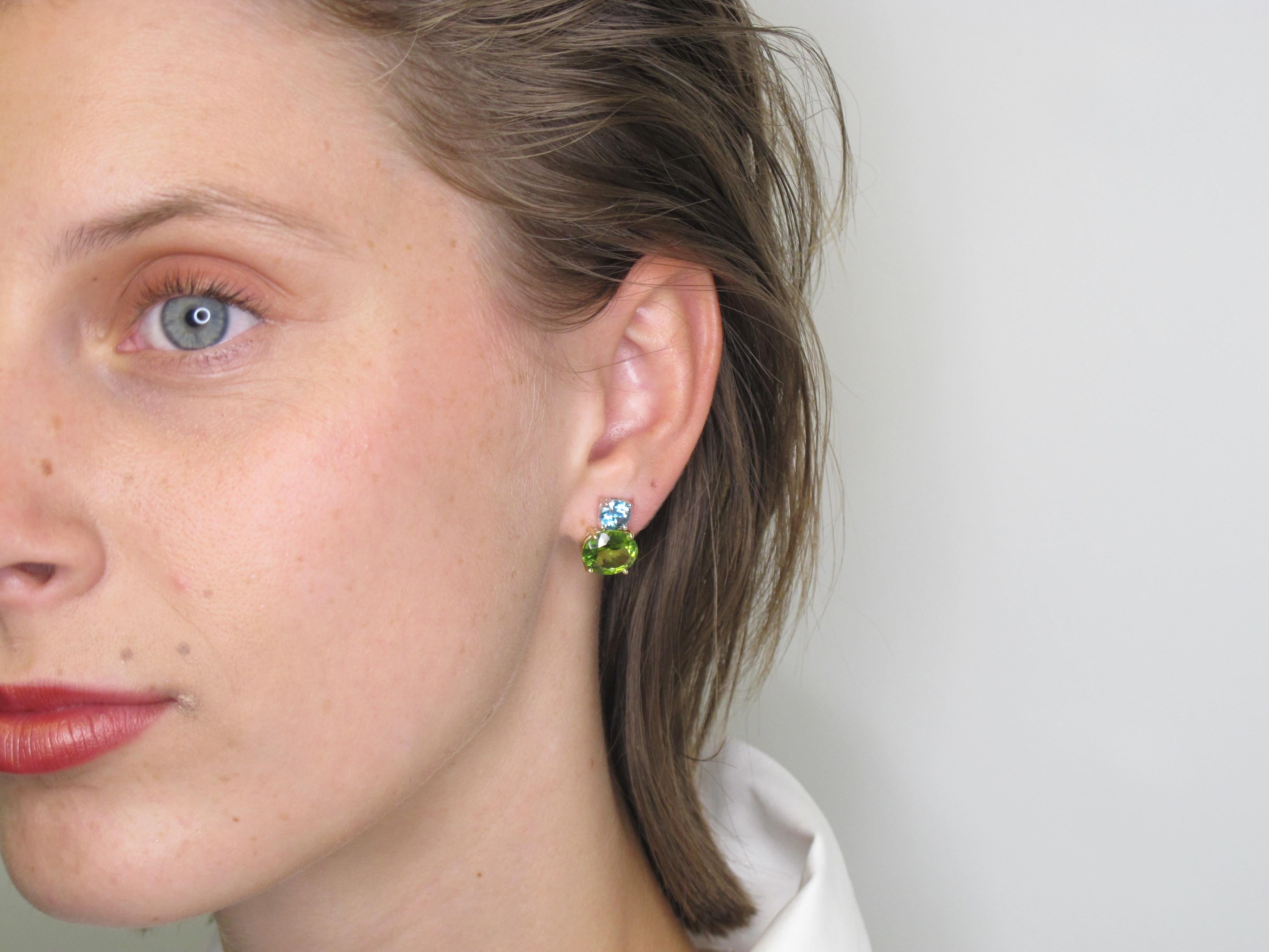 Add a pop of color to light up your life! These earrings are bright and cheery and pack a punch! Oval peridots are paired with round blue zircons for a gorgeous combination of color. The 