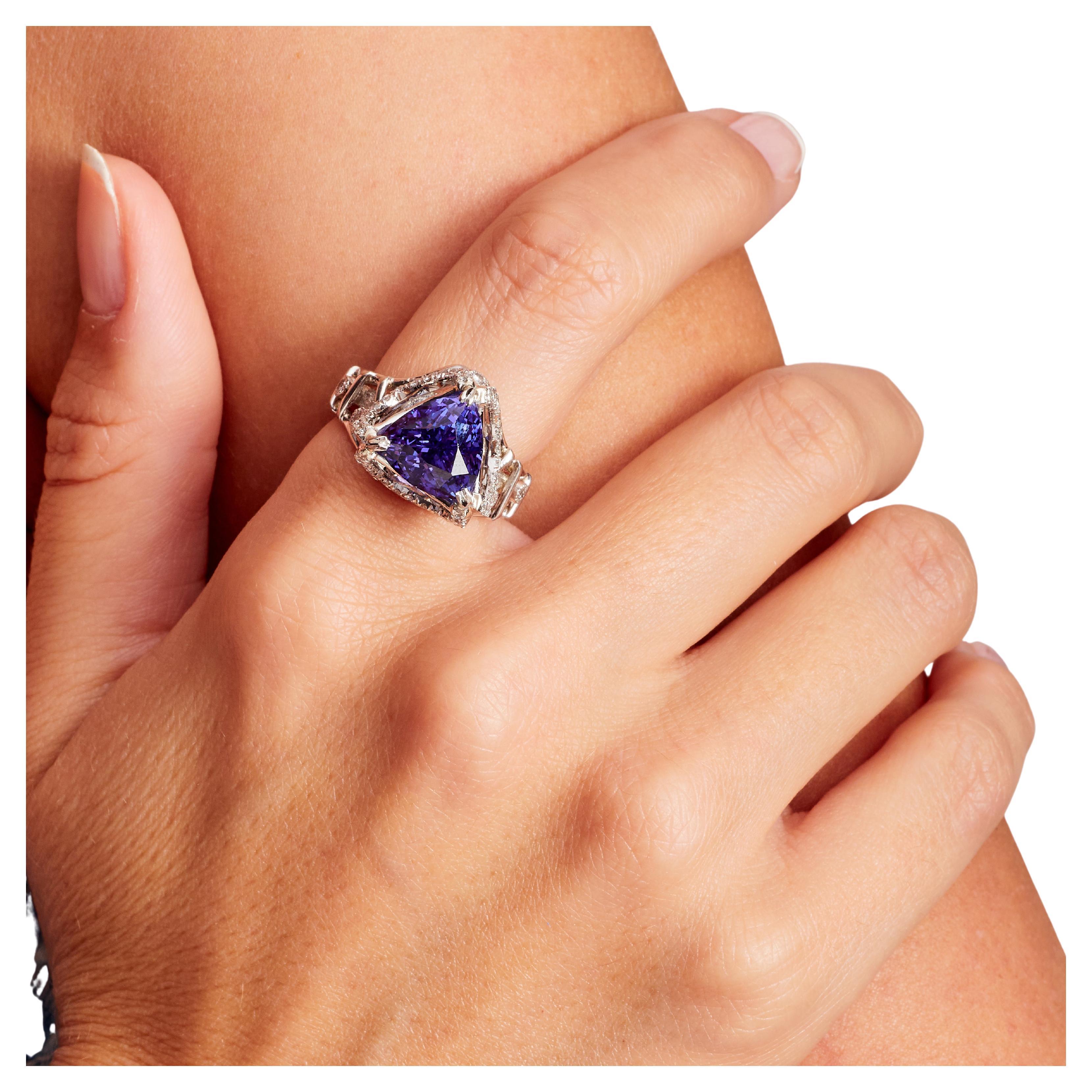 6.54 Carat Tanzanite, Diamond, Platinum Cocktail Ring, In Stock. This large trillion-cut tanzanite (H) statement ring features a big indigo stone set in platinum with pave diamonds on the shoulders and prongs. This tanzanite trillion (H) center