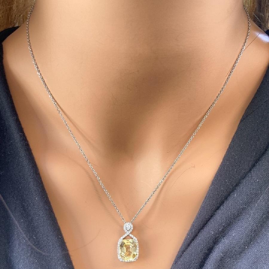 This exquisite pendant features a breathtaking 6.54-carat yellow cushion sapphire, celebrated for its vibrant, golden-yellow hue and exceptional brilliance. The sapphire is elegantly highlighted by 43 round diamonds, totaling 1.11 carats, which