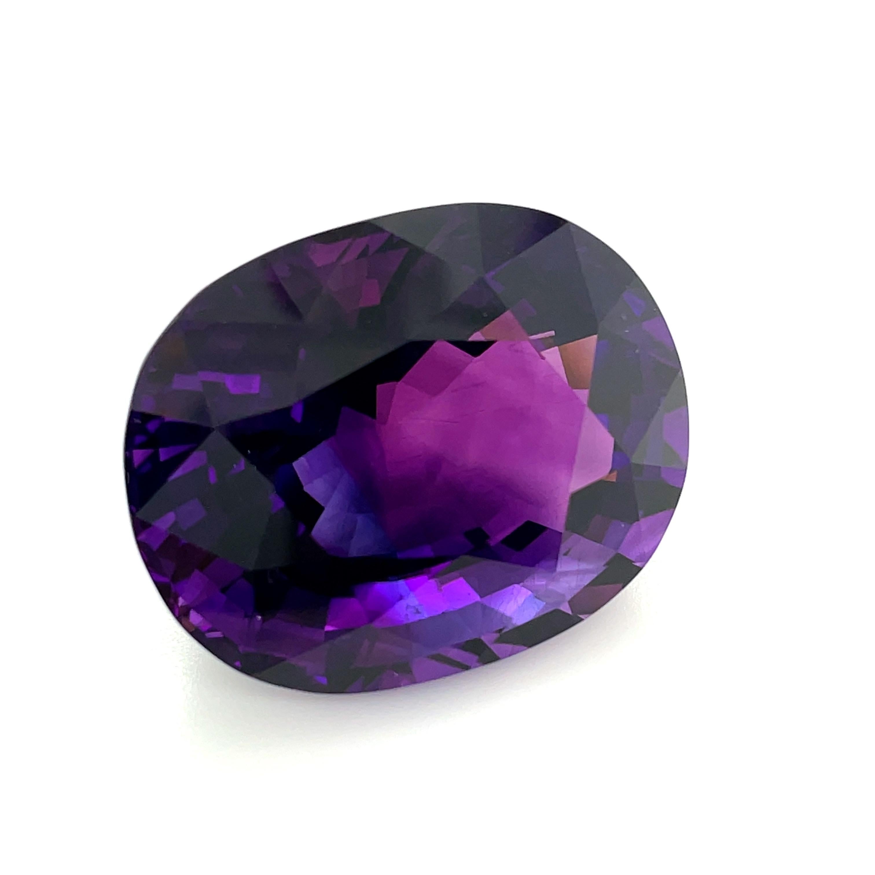 This luscious royal purple amethyst weighs 65.49 carats and would make a perfectly regal and eye-catching pendant! It is beautifully faceted and crystal clean, with velvety rich purple color and both pinkish-purple and bluish-purple highlights. This