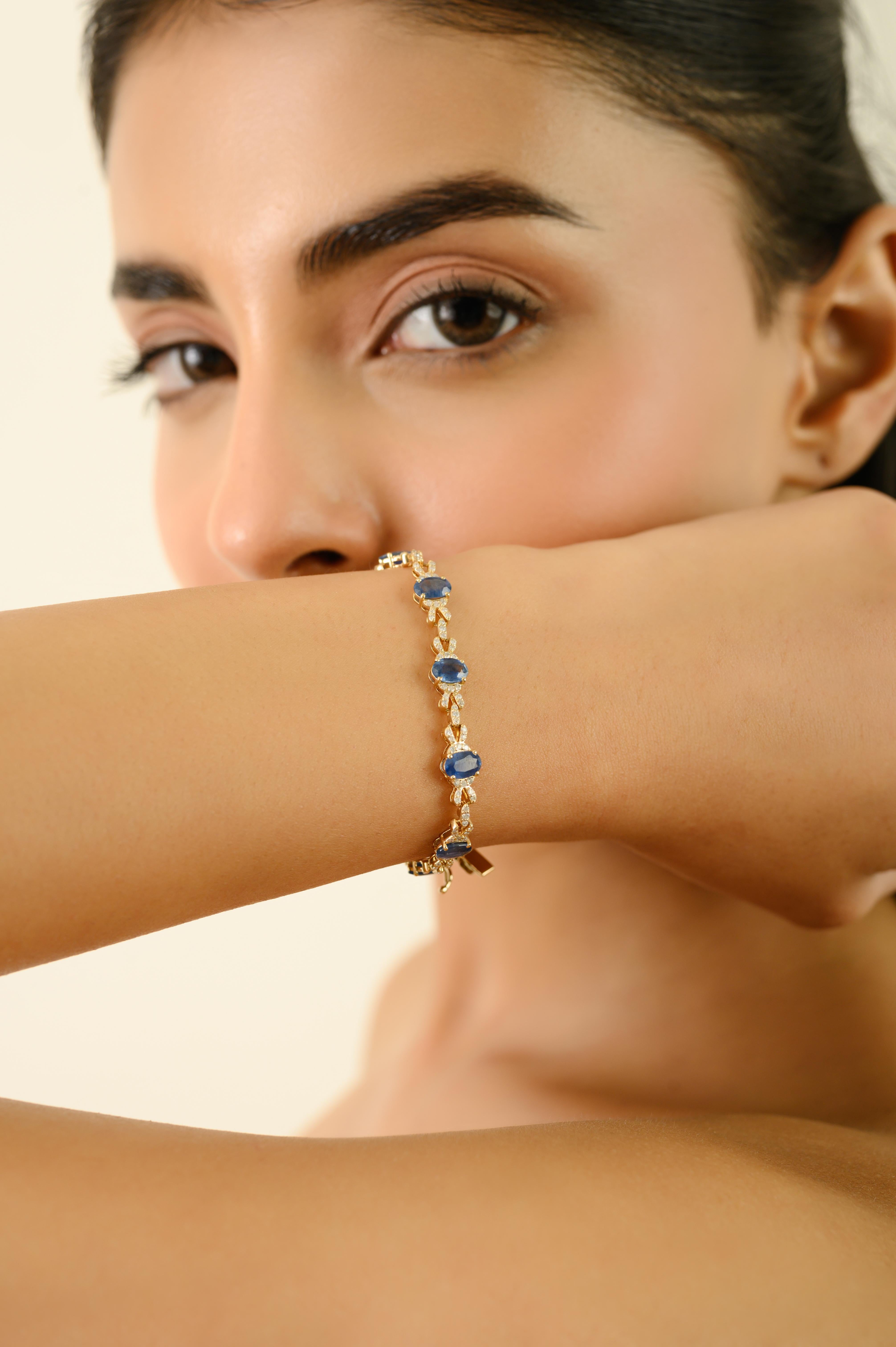 This tennis bracelet features 12 oval cut blue sapphires totaling 6.54 carats, set in rich 14k yellow gold. Each sapphire is securely set in a classic four-prong setting, measuring approximately 5 x 4 mm. Between every sapphire, a graceful