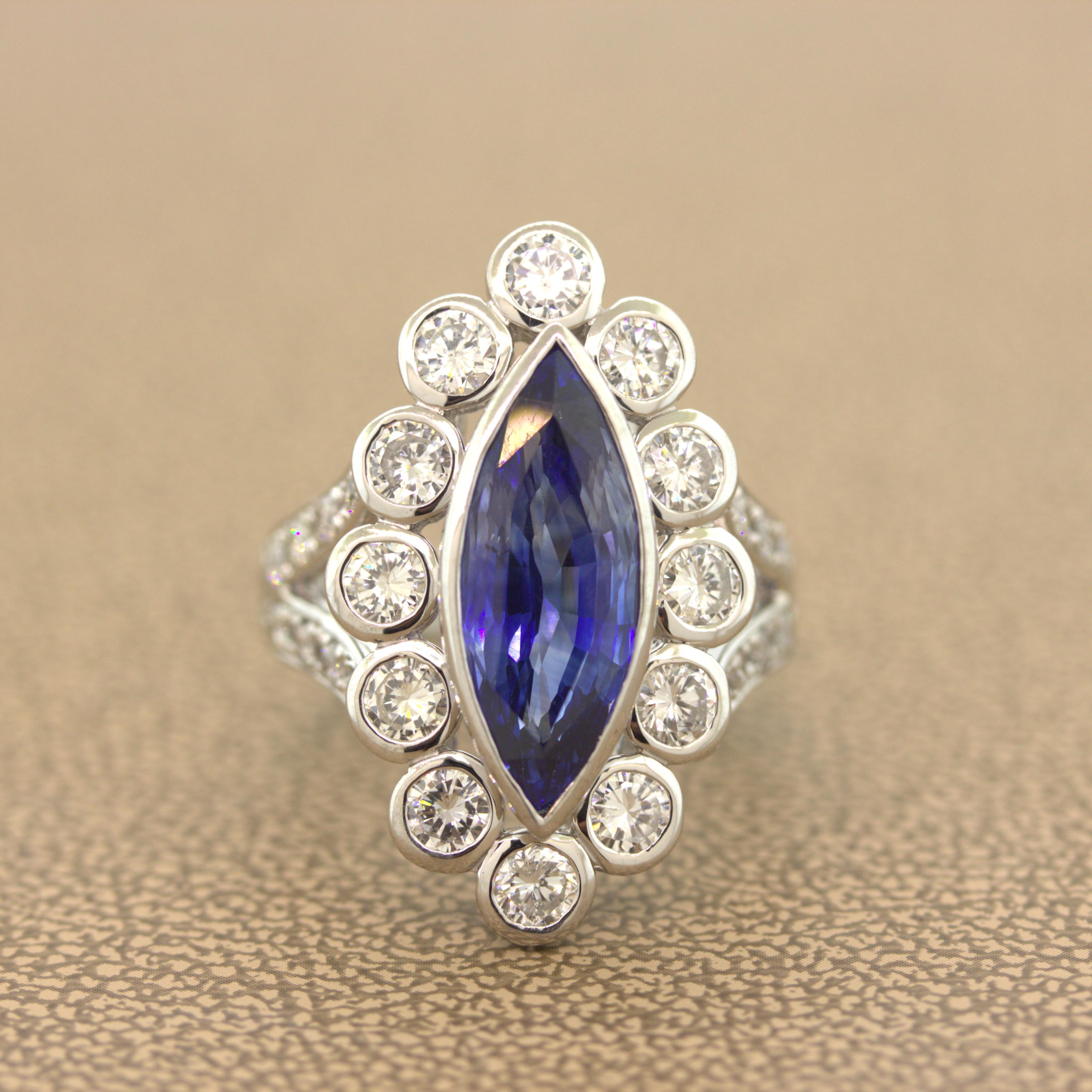 A classic navette ring featuring a long marquise-shape Ceylon sapphire weighing 6.55 carats. It has been certified by the GIA as natural and has a rich bright blue color with excellent clarity as the stone has no eye visible inclusions. Surrounding