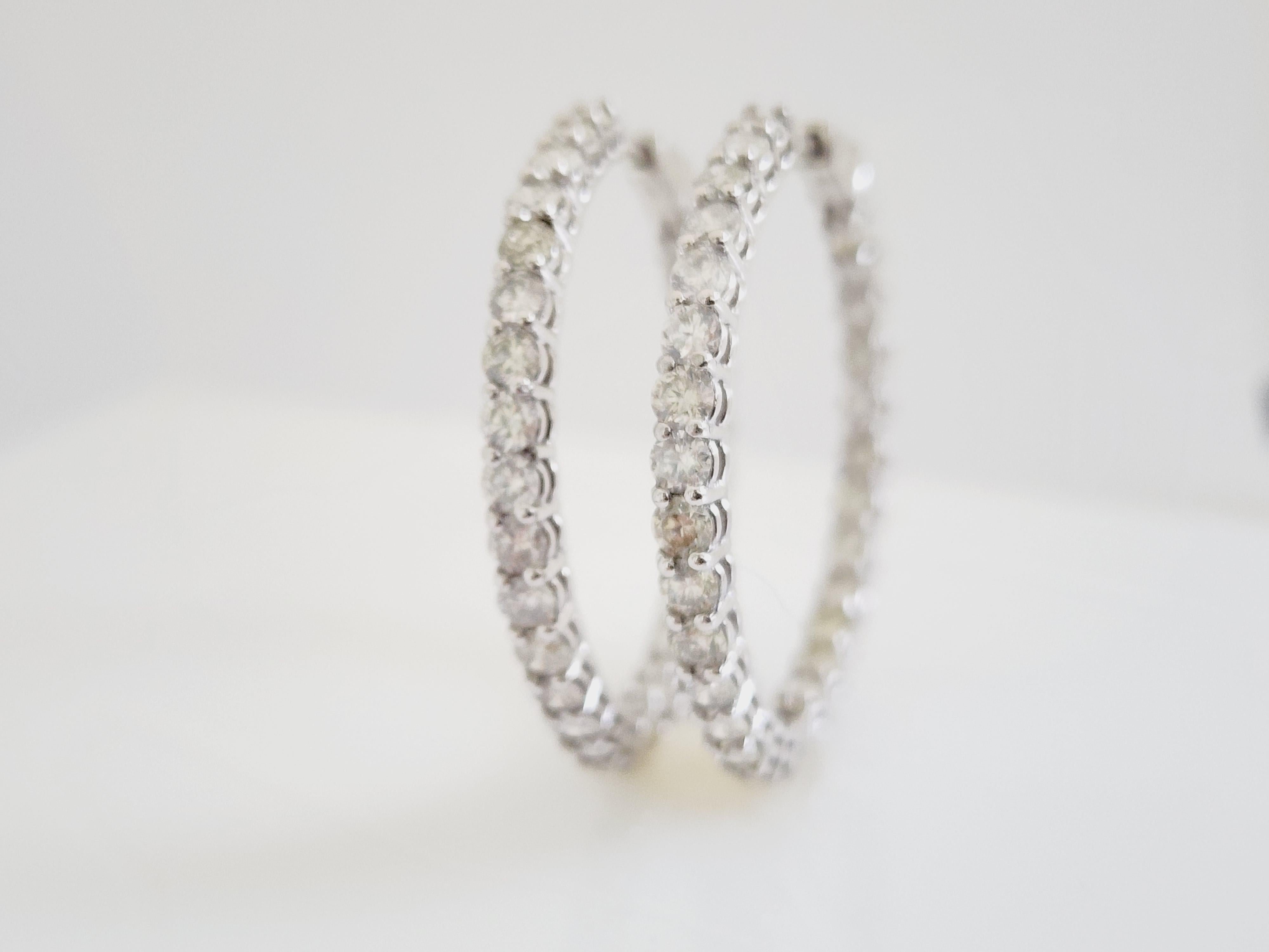 Beautiful pair of natural diamond inside out hoop earrings in 14K white gold. 
Secures with push snap closure for easy wear. 
Average Color I, Clarity SI, 
Measures 1.25 inch diameter. 