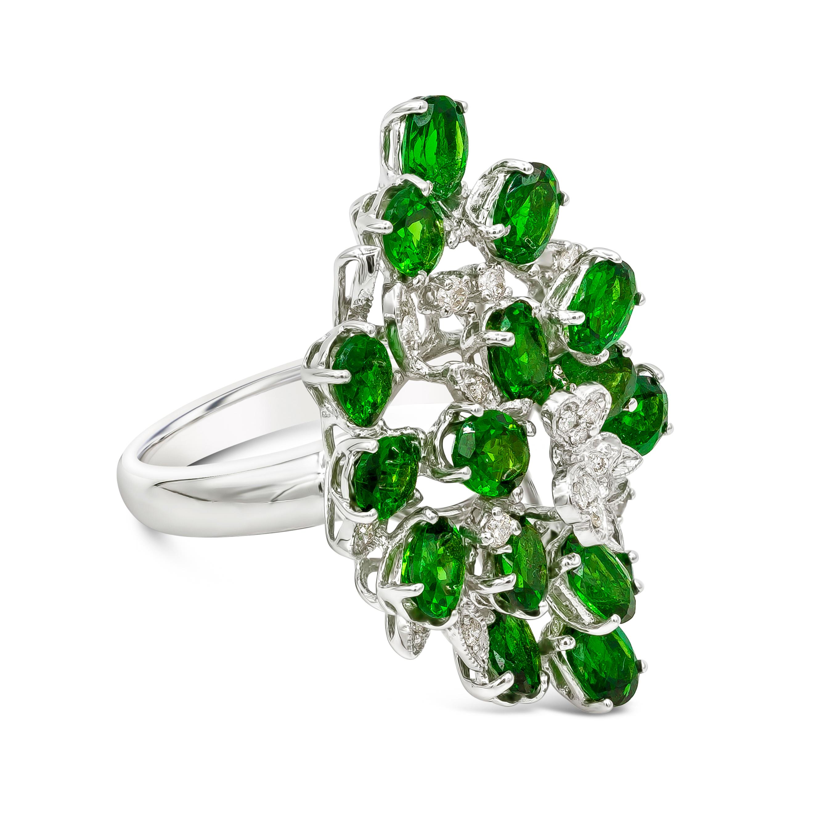 A piece of jewelry showcasing 17 color-rich oval cut tsavorite stones and 19 brilliant round diamonds that weighs 0.28 carats total. Tsavorite stones weighs 6.55 carats total. This magnificent open work design fashion ring is made in 18 karats white