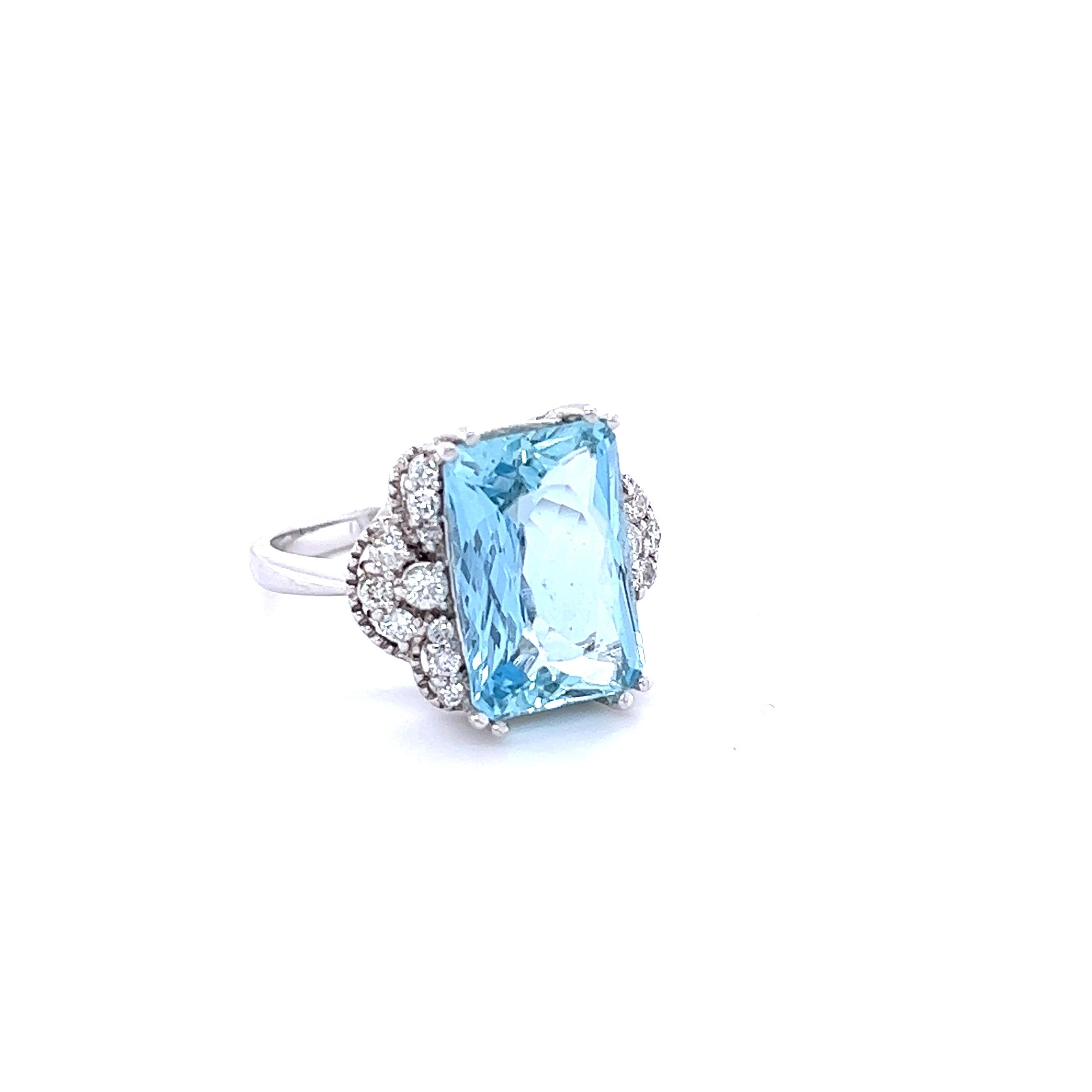 This ring has a 6.12 Carat Emerald Cut Aquamarine set in the center of the ring and is surrounded by 20 Round Cut Diamonds that weigh 0.44 carat (Clarity: VS2, Color: F). The total carat weight of this ring is 6.56 carats. 
The Aquamarine measures
