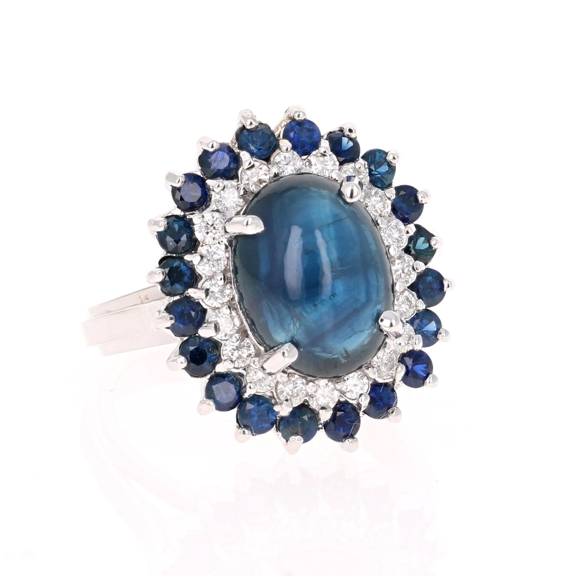 Beautiful and Charming Cabochon Cut Sapphire Diamond Ring! This ring has a stunning Oval Cabochon Cut Blue Sapphire that weighs 5.20 carats. The Sapphire is surrounded by 20 Round Cut Diamonds that weigh 0.36 carats (Clarity: SI, Color: F) and also