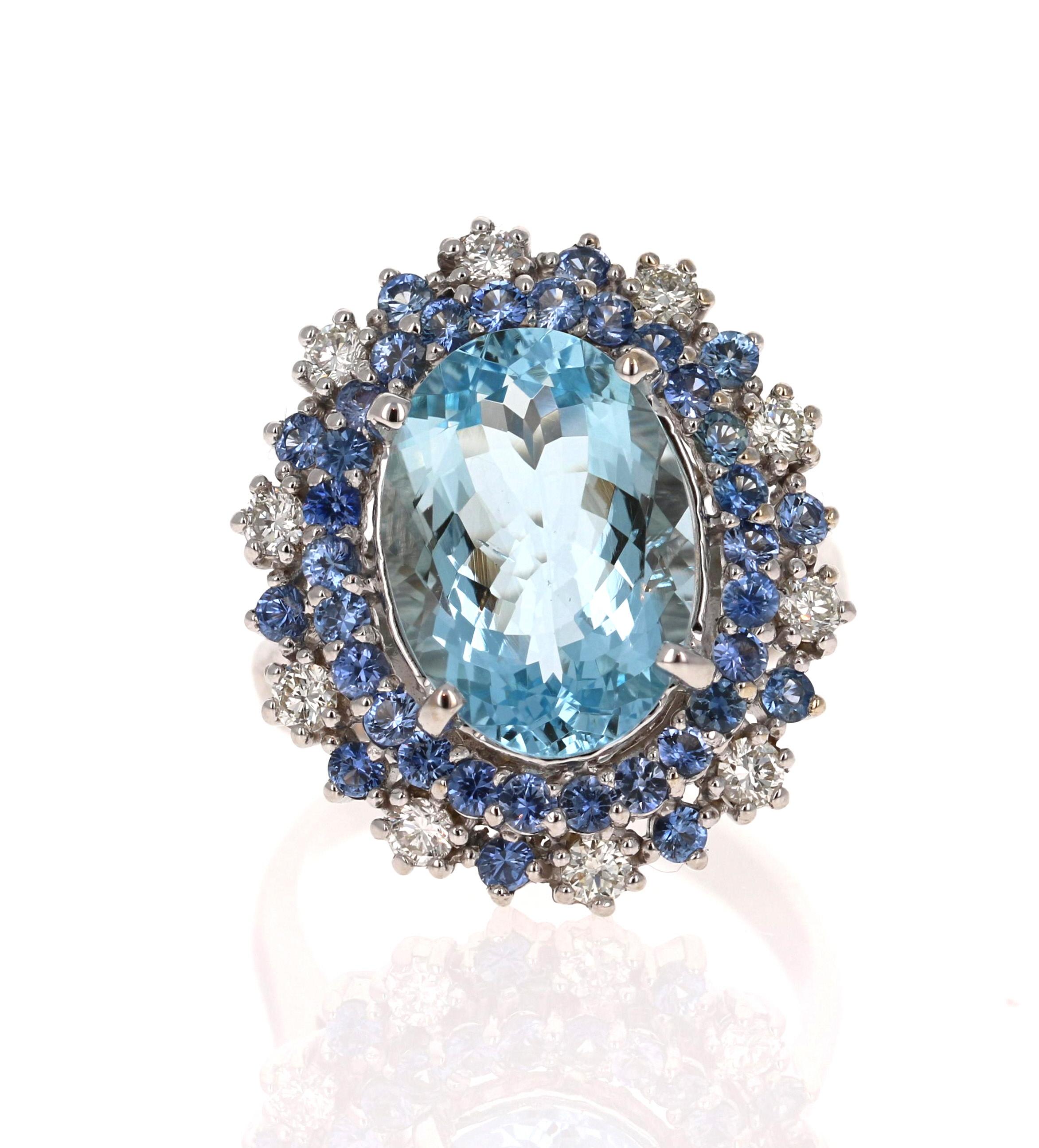 This ring has a beautiful 4.57 Carat Oval Cut Aquamarine and is surrounded by 36 Round Cut Sapphires that weigh approximately 1.57 carats and 10 Round Cut Diamonds that weigh 0.43 Carats (Clarity: VS, Color: H). The total carat weight of this ring