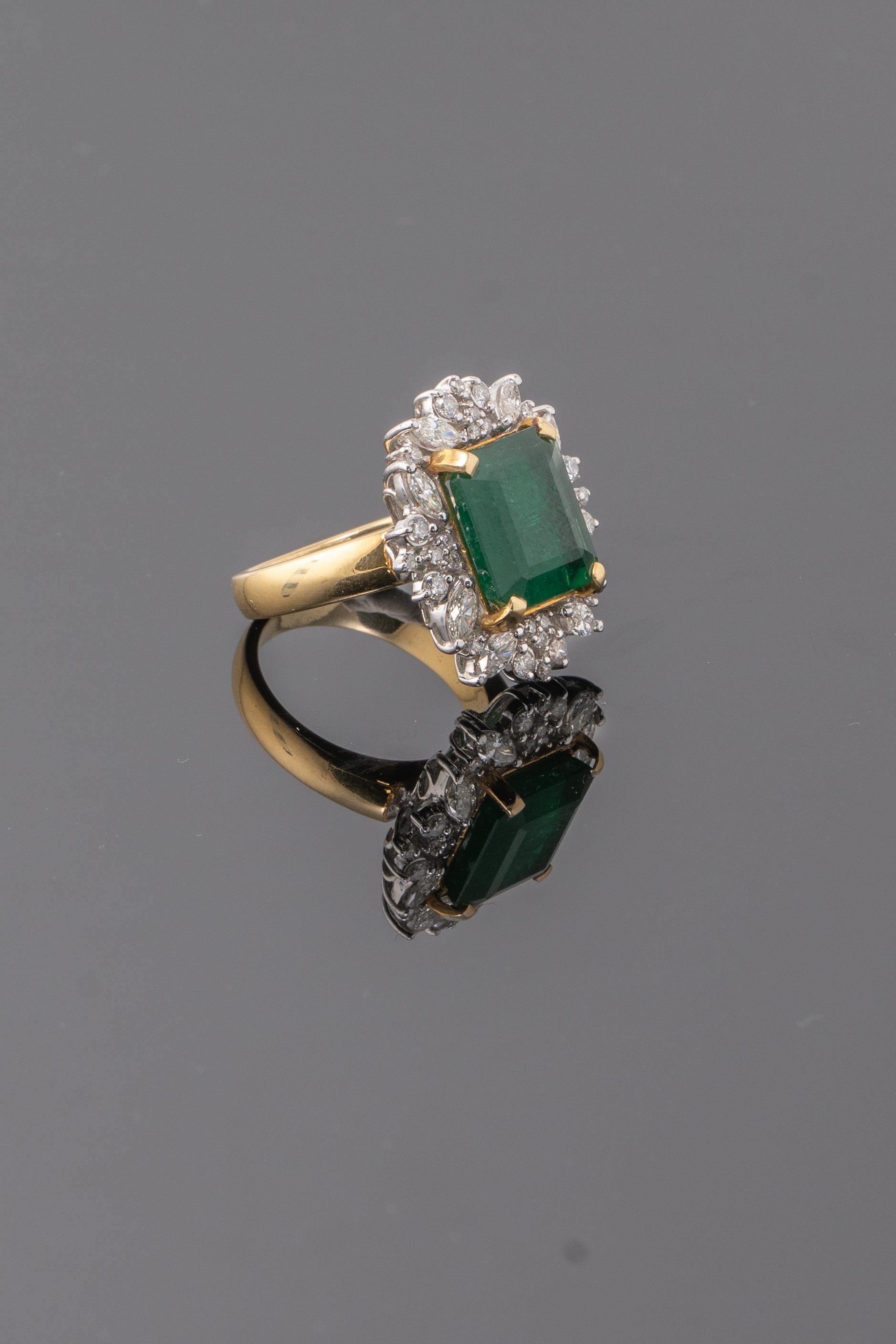 A stunning 6.57 carat Zambian Emerald and Diamond cocktail ring, set in 18K Yellow Gold and White Gold (Diamond part). The ring is currently sized at US 6.5, can be resized. 
Please feel free to message us if you have any queries. 
Free shipping