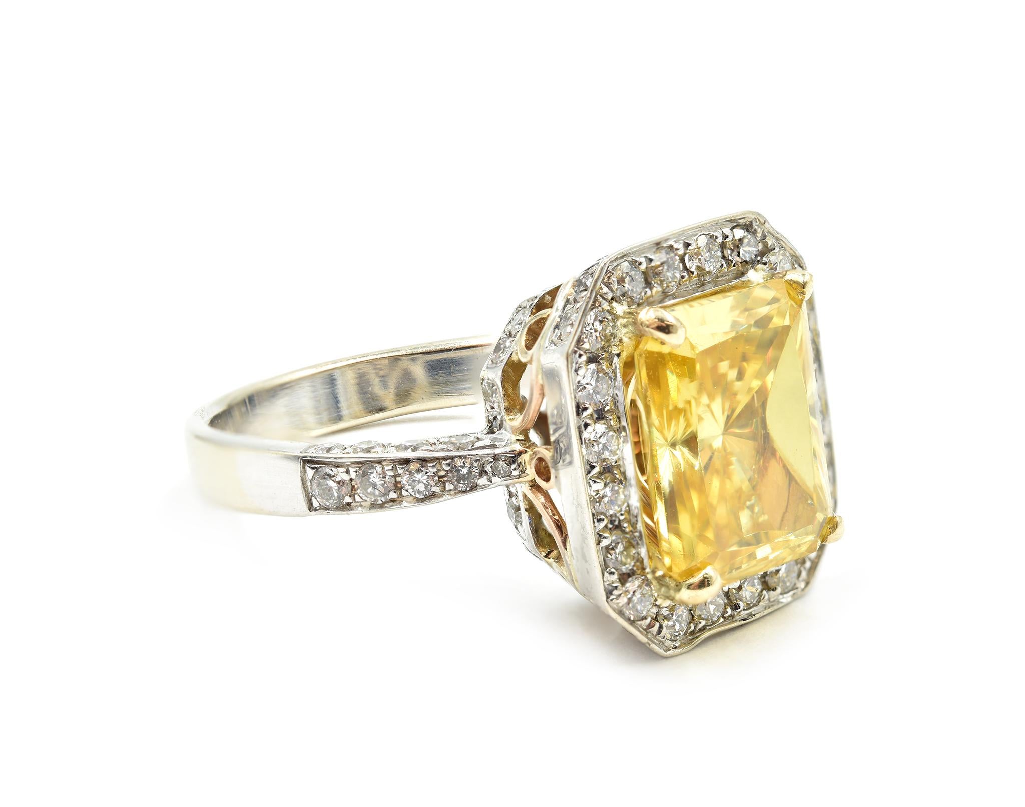 Designer: custom design
Material: 18k white gold
Center Diamond: radiant cut 6.57 carat simulated yellow diamond
Accent Diamonds: 80 round brilliant diamonds = 1.08 carat weight
Total Carat Weight: 7.65 carat total weight
Dimensions: ring top