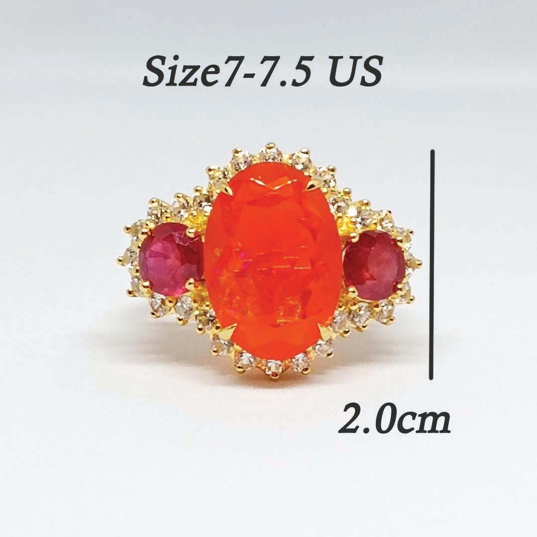 Orange Opal Oval 15.4x11x6 mm.    1 pc.
Ruby Round 6 mm. 1.95 cts.    2 pcs.
White zircon round. 2.10 mm. 28 pcs.
Sterling Silver on 18K Gold Plated.
Size ring. 7-7.5 US.

