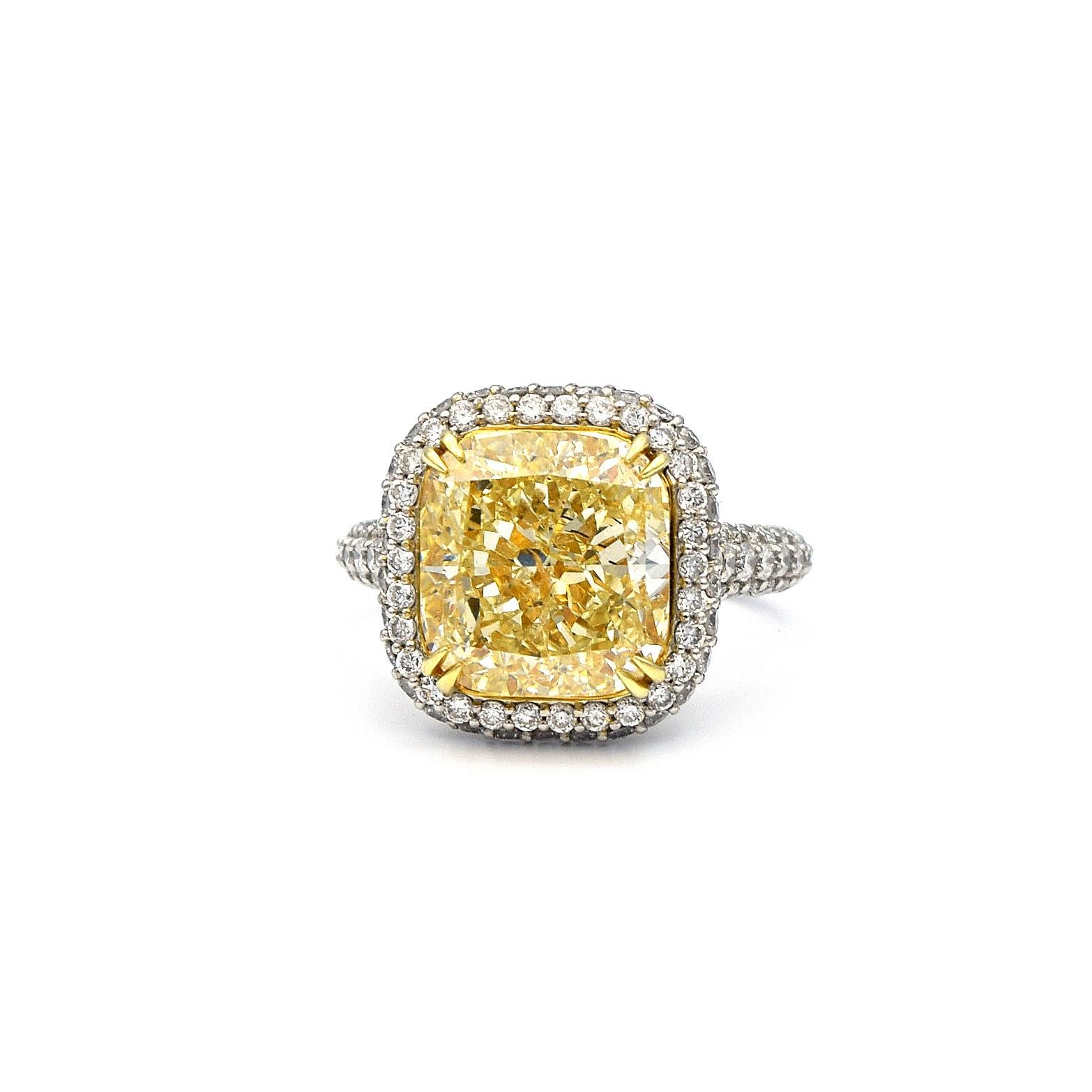 This lovely ring has a center stone weighting 6.58 Carat, is EGL Certified Fancy Light Yellow Cushion SI2. The ring also has 1.35 Carats of White Pave Diamonds and is mounted in Platinum and 18K White Gold.
Ring size is 5.75