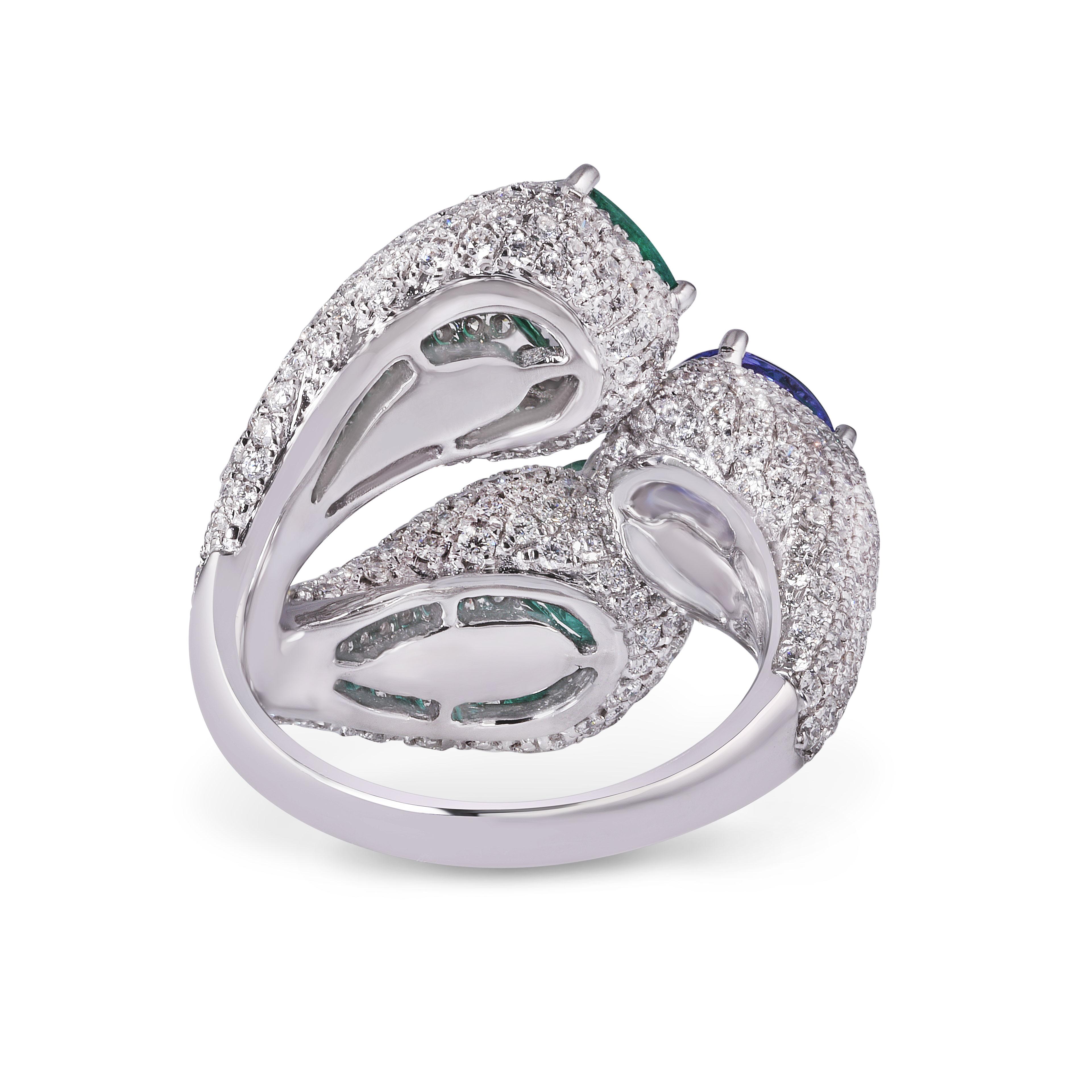 Inspired by the wreathing curl of nature's vines, this pave diamond set ring envelopes the finger, culminating in vivid cushion cut emeralds and a 1.28ct Tanzanite. 

Tanzanite weight 1.28cts.
Total diamond weight 2.93cts. 
Diamonds are G/H colour