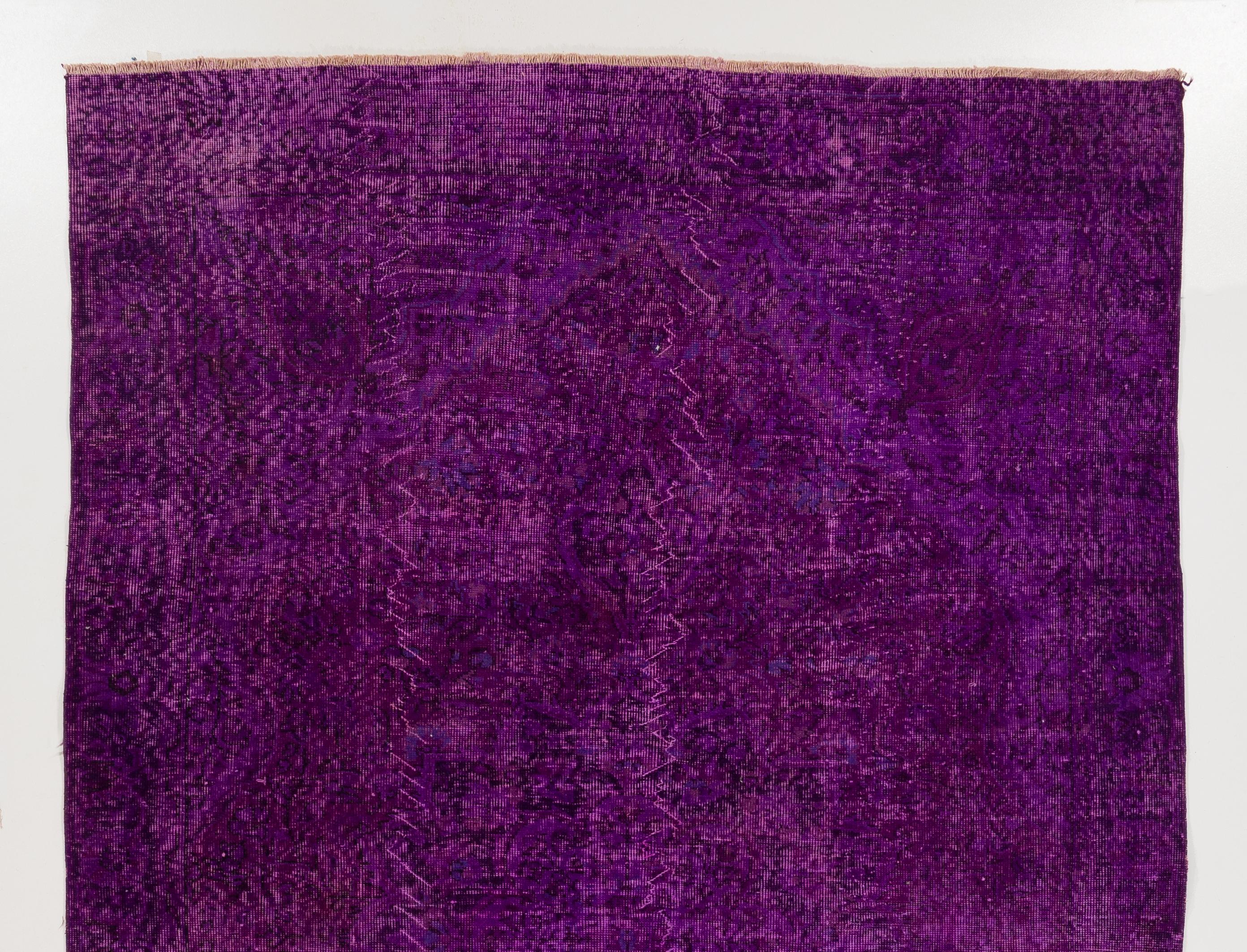 A vintage central Anatolian area rug re-dyed in purple color for contemporary interiors.
Finely hand knotted, low wool pile on cotton foundation. Professionally washed.
Sturdy and can be used on a high traffic area, suitable for both residential