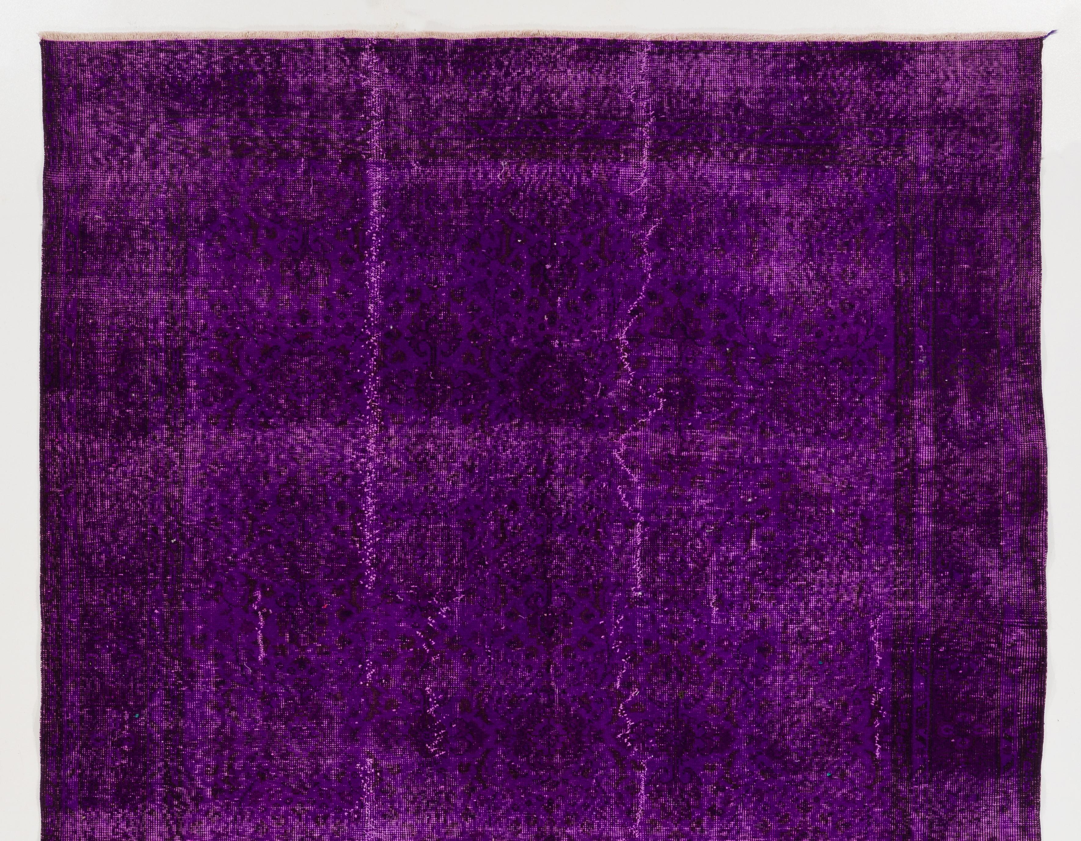 A vintage Turkish area rug over-dyed in purple color. Measure: 6.5x9.6 ft.
Finely hand knotted, low wool pile on cotton foundation. Deep washed.
Sturdy and can be used on a high traffic area, suitable for both residential and commercial interiors.