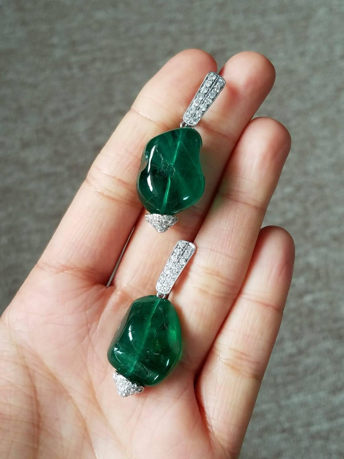 A pair of very unique drops earring, using Emerald tumble beads of great colour and clarity and Diamond set in 18K white gold. 

Stone Details: 
Stone: Zambian Emerald
Carat Weight: 66.0 Carats

Diamond Details: 
Total Carat Weight: 1.5