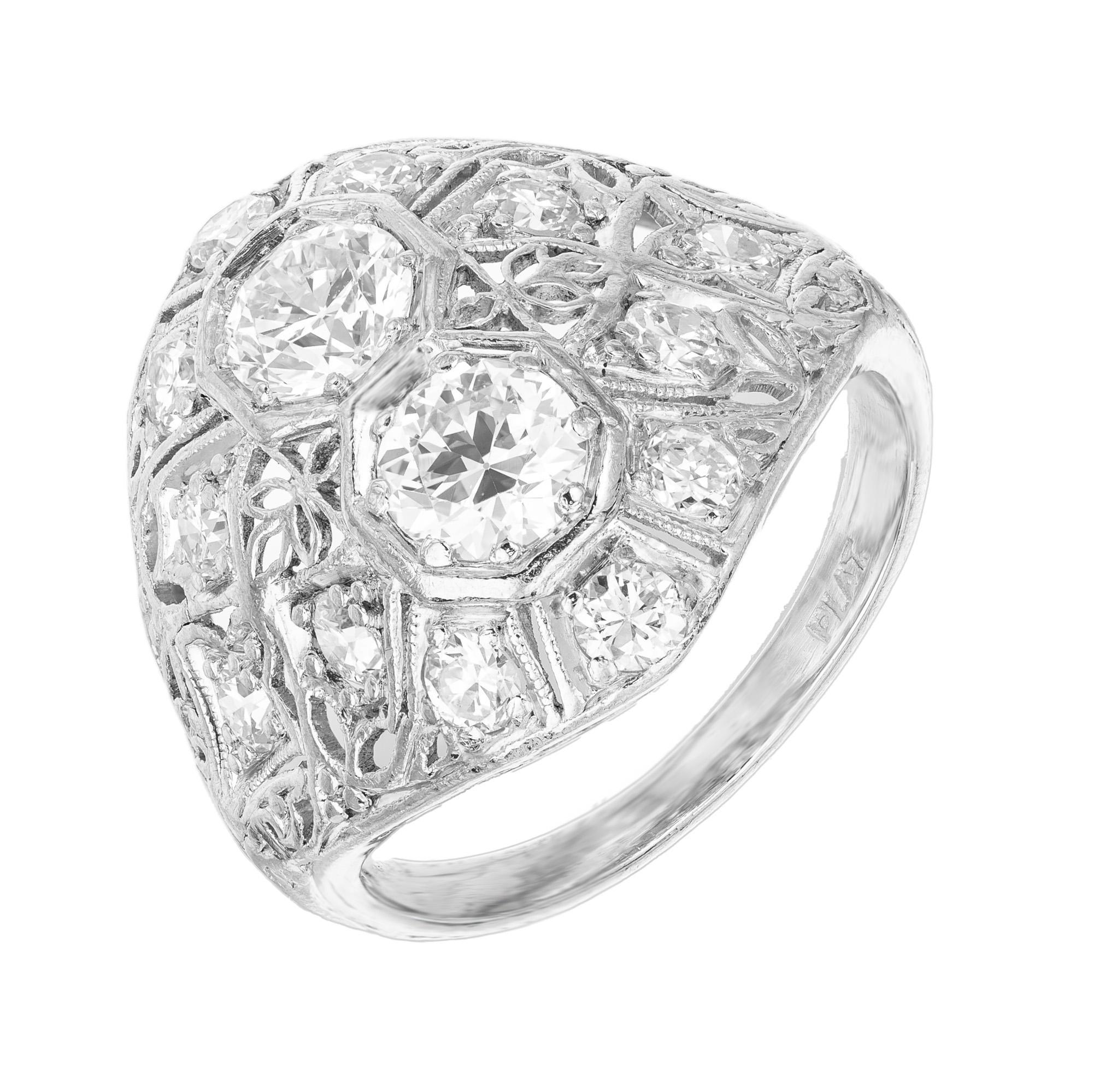 1930's handmade diamond dome ring. Steeped in the enchanting elegance of the Art Deco era, this hand pierced and hand engraved platinum setting is mounted with 2 Old European cut diamonds totaling .66 Carats. Accented with 12 full cut diamonds.