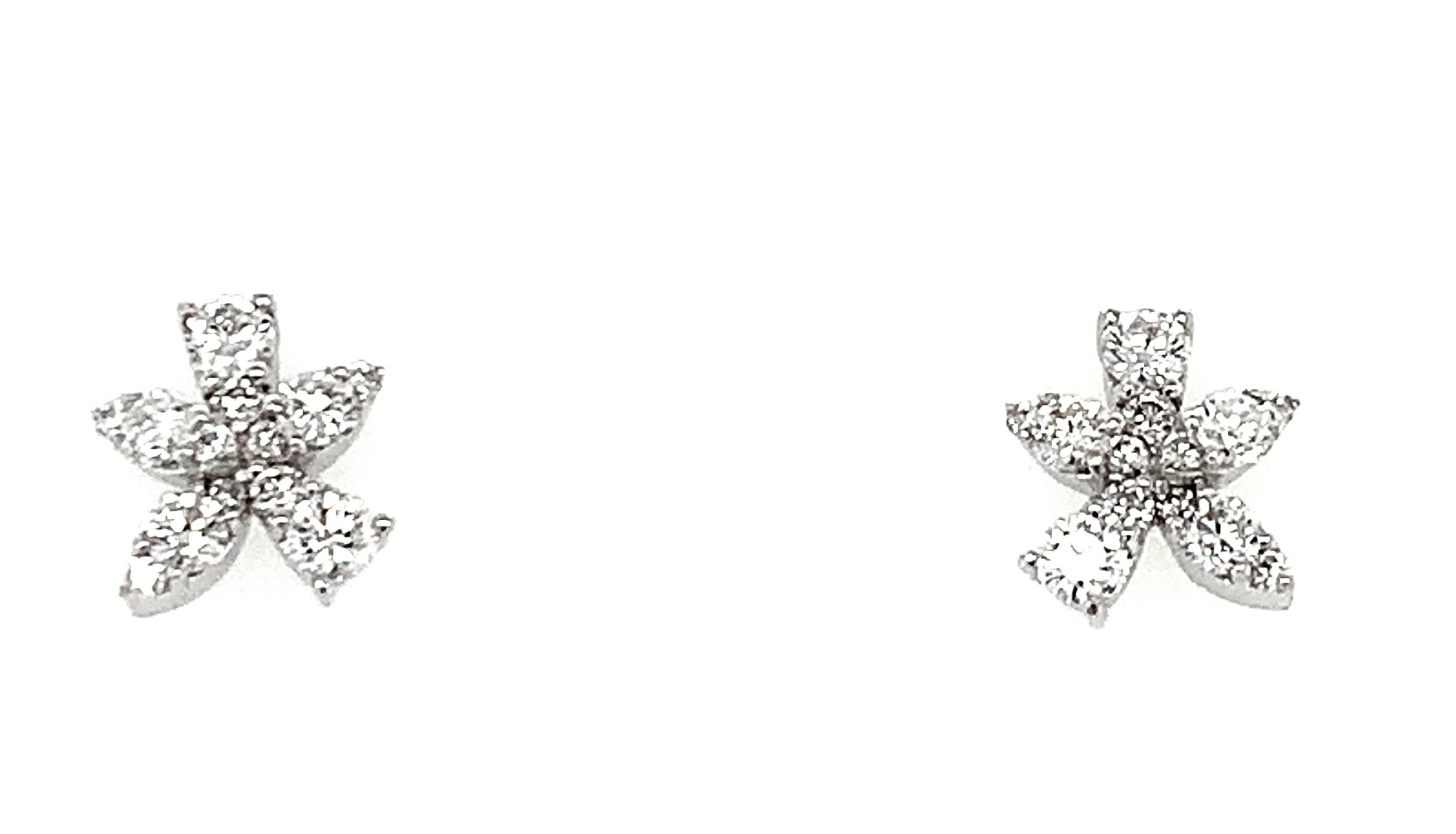 Everyone needs a pair of pretty diamond studs in their fine jewelry collection! These are unusual little floral starburst patterns rendered in diamonds. Extremely versatile, they can be dressed up or down depending on your mood. Twenty-six round