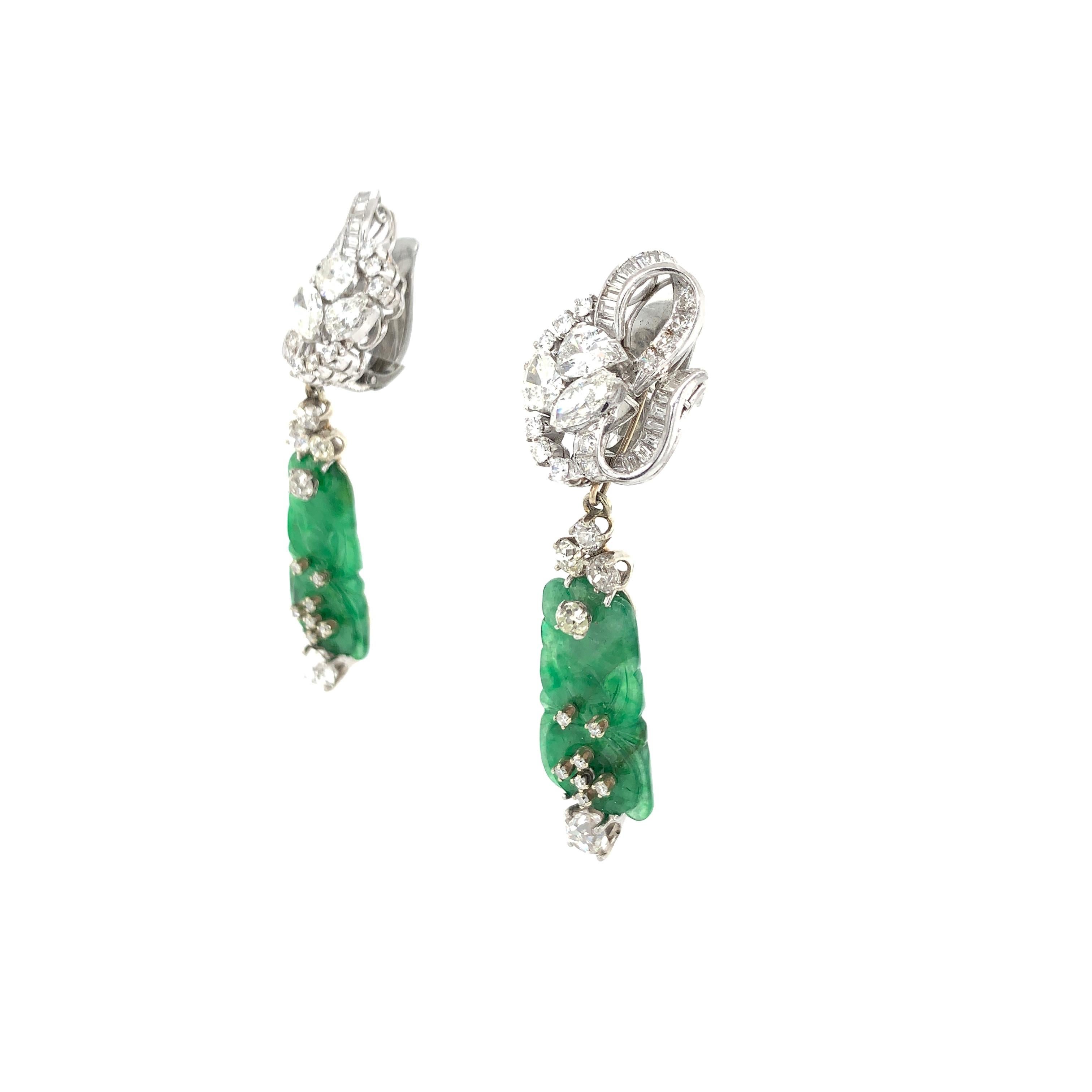 The floral ribbon surmounts set with pear-shaped, marquise-cut, baguette-cut and round diamonds, suspending a pair of elongated carved jadeite plaques measuring 25.5 x 13.5 x 2.5 mm, with bat motifs accented by old mine-cut and round diamonds, the