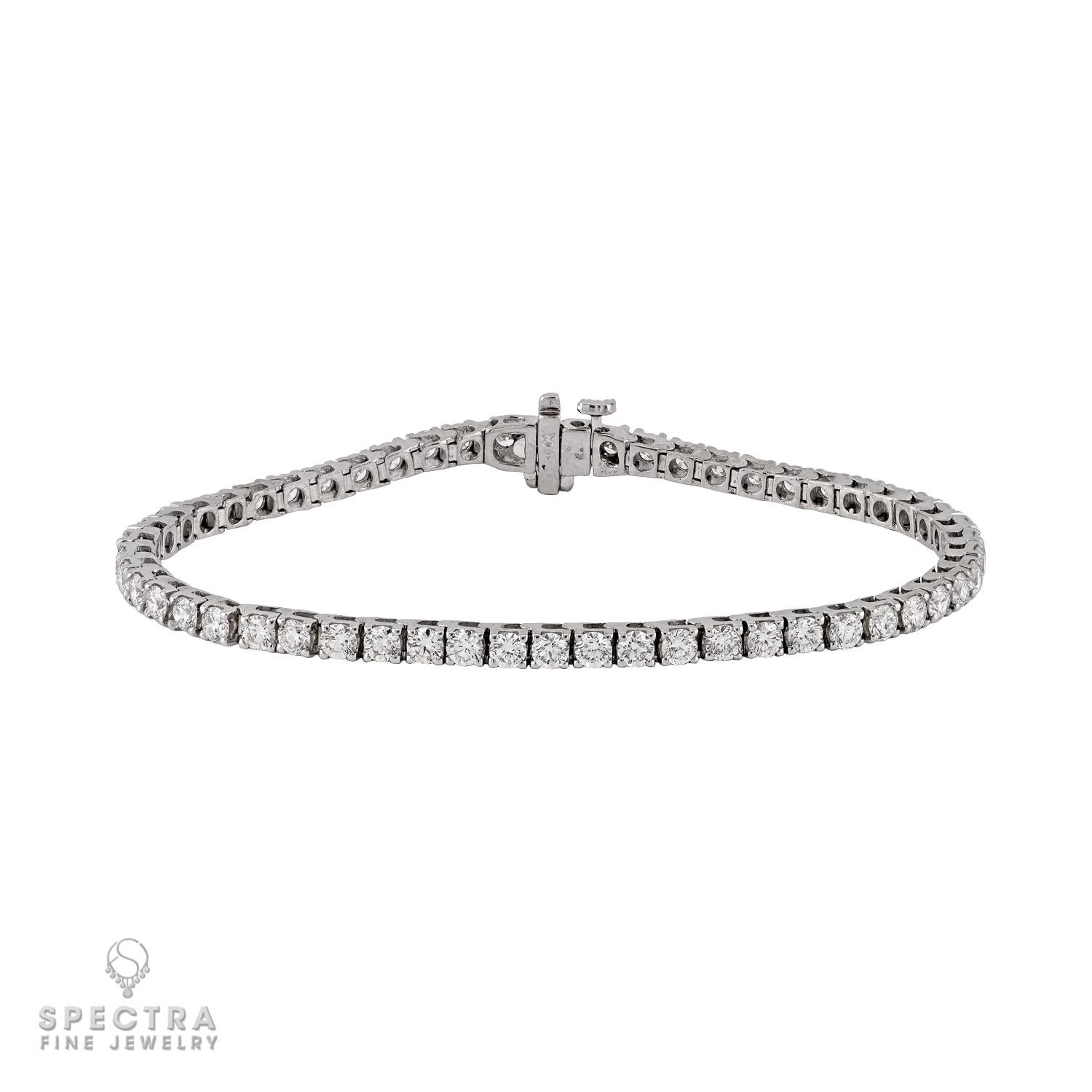 A timeless expression of elegance, this exquisite diamond tennis bracelet is designed to capture light with every movement. Meticulously crafted in 14k white gold, it features 55 natural round brilliant-cut diamonds, each weighing approximately 0.12