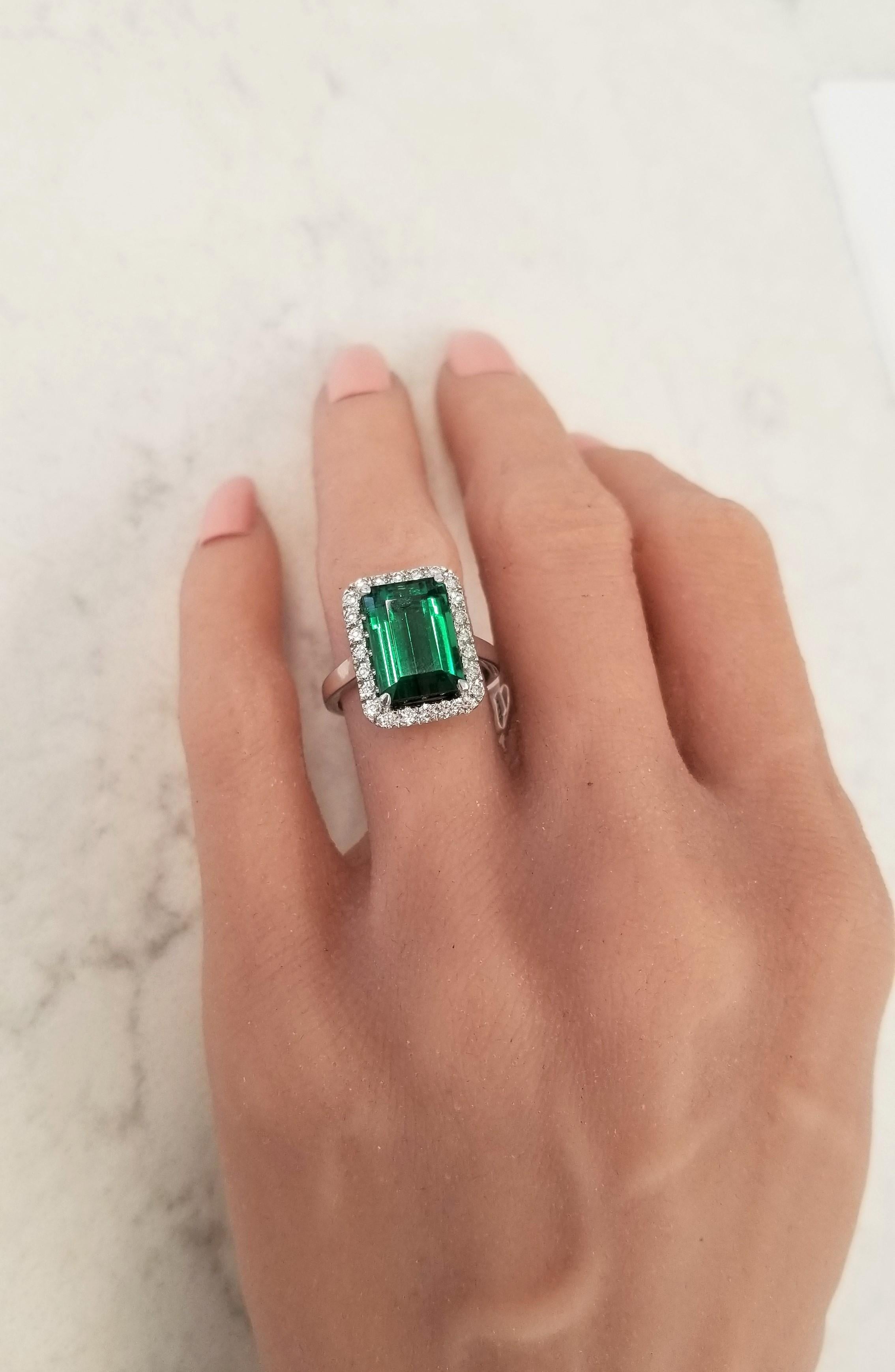 This is a 6.60 carat emerald-cut, lush grass green, tourmaline measuring 12.58 X 8.62mm. Its gem source is Brazil. This gem's main exhibit is its clean, crisp spring forest green hue. Its transparency and luster are superb. A total of 24