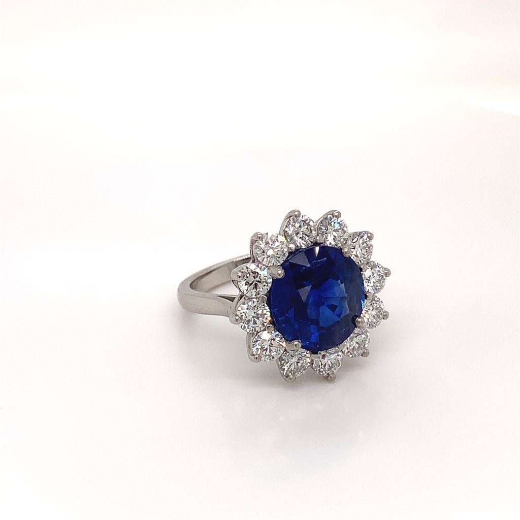 This magnificent masterpiece features a phenomenal Round Brilliant blue Sapphire weighing 6.10 carats at its centre, it's splendour complimented perfectly by the 12 scintillating Round Brilliant Diamonds surrounding it. The flawless diamonds on this