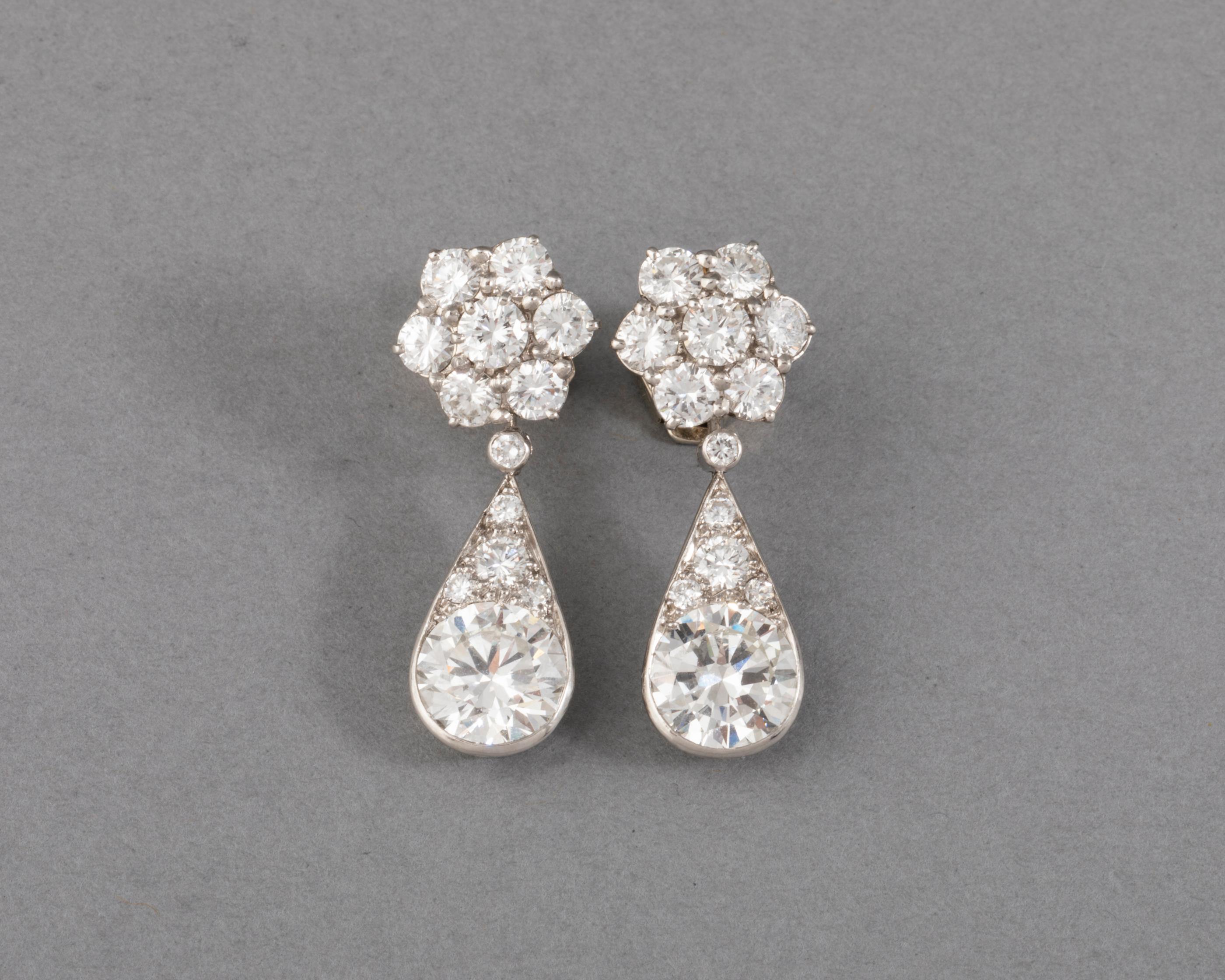 6.60 Carats Diamonds French Art Deco Earrings

Very beautiful pair of earrings, made in France circa 1930.

Made in Platinum (dog head marks) and white gold (eagle head marks).
Mark of the Maker (Unknown).
The diamonds are very good quality, the two