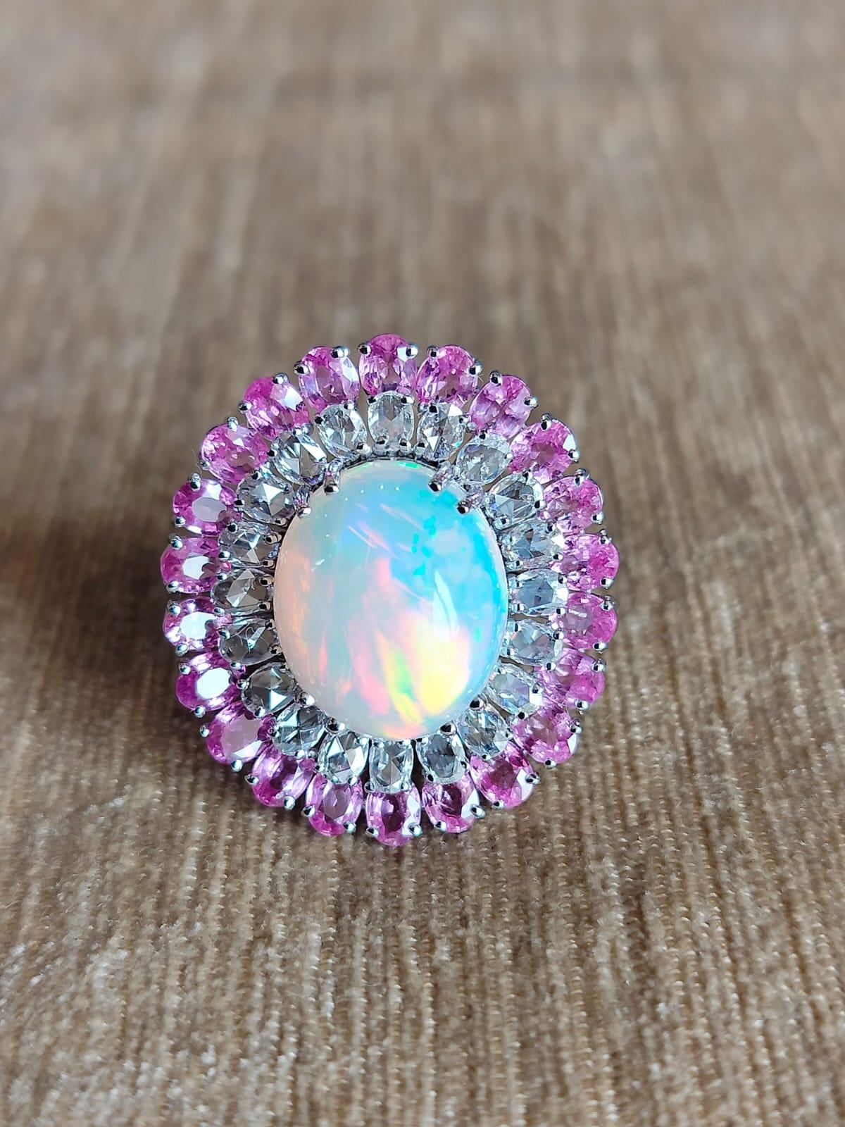 A classic Art Deco style Opal and Pink Sapphire Cocktail ring set in 18K White Gold & Diamonds. The weight of the Opal is 6.6 carats. The Opal is of Ethiopian origin. The weight of the Pink Sapphire is 4.80 carat. The pear shaped Pink Sapphires are