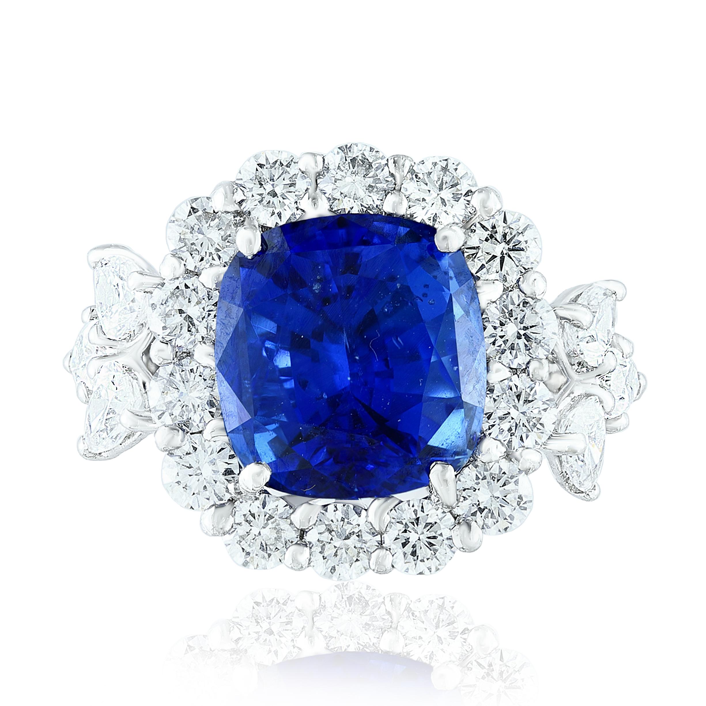 A brilliant and unique piece featuring a cushion cut Blue Sapphire and brilliant cut round and pear shape diamonds.
Blue Sapphire in the center weighs 6.61 carats total; 14 round diamonds surrounding the center stone weigh 1.72 carats total. 6 pear