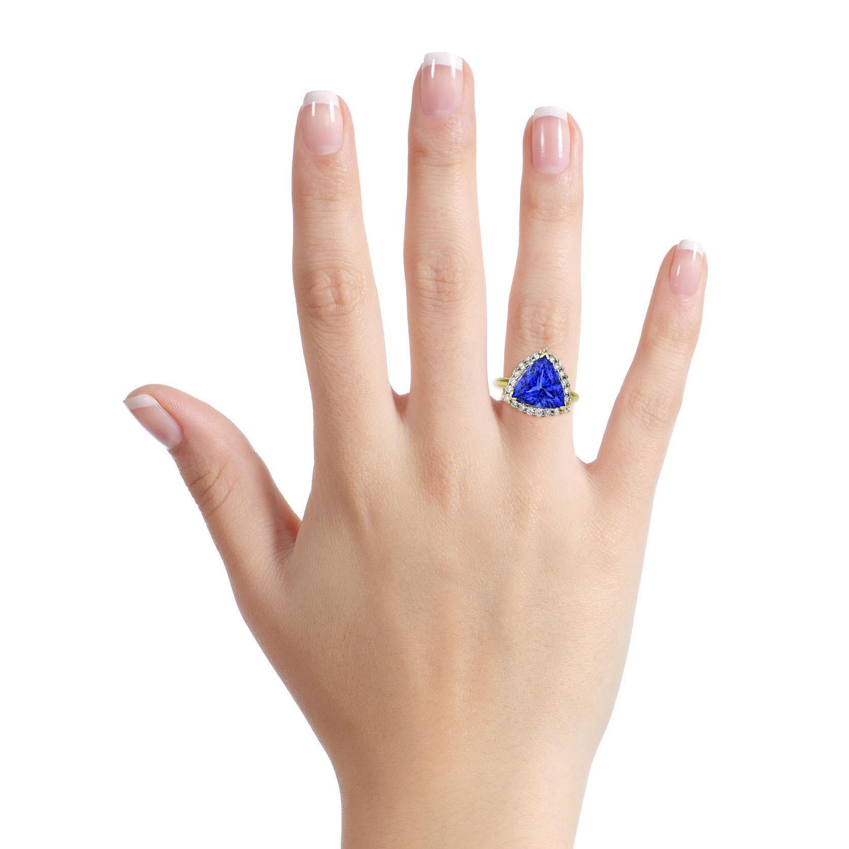 Tanzanite and Diamond ring in 14-karat yellow gold. The polished metal setting has a trillion cut natural Tanzanite center surrounded by 21 brilliant round diamonds. Comes with appraisal. Replacement value $12,000. 

Size, 6.25
Height, 16mm
Width,