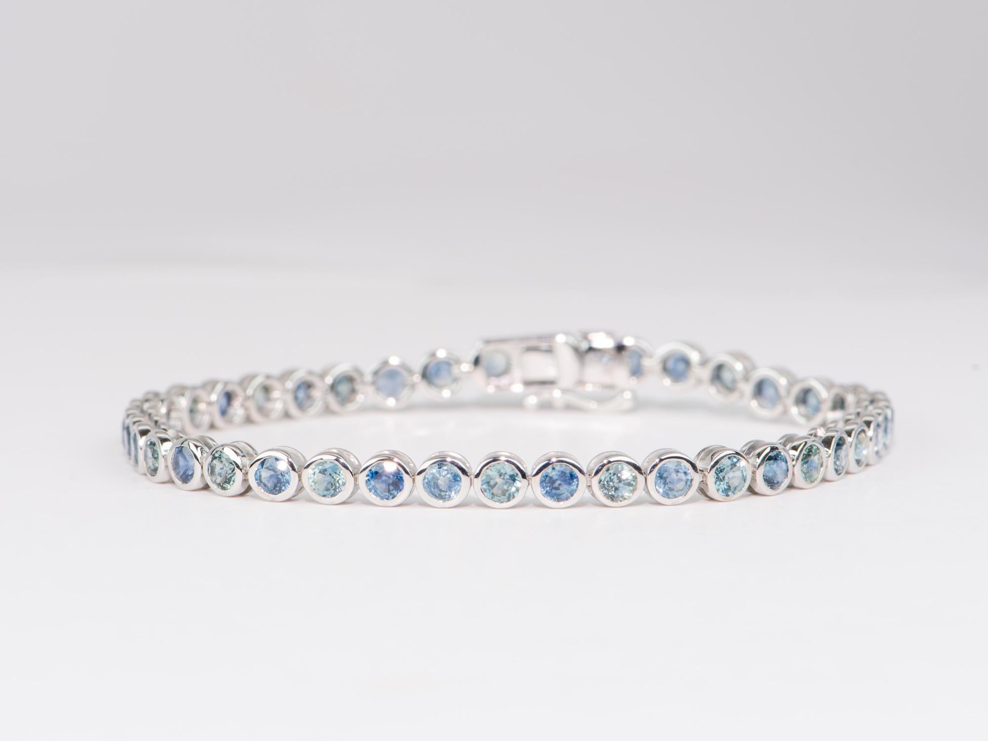 This sublime and exquisite Montana Sapphire Bezel Set Bracelet is crafted from 14K White Gold and set with breathtakingly brilliant sapphires, all mined in the USA. The soft blue sapphires create a refined and sensational look. Perfect for the