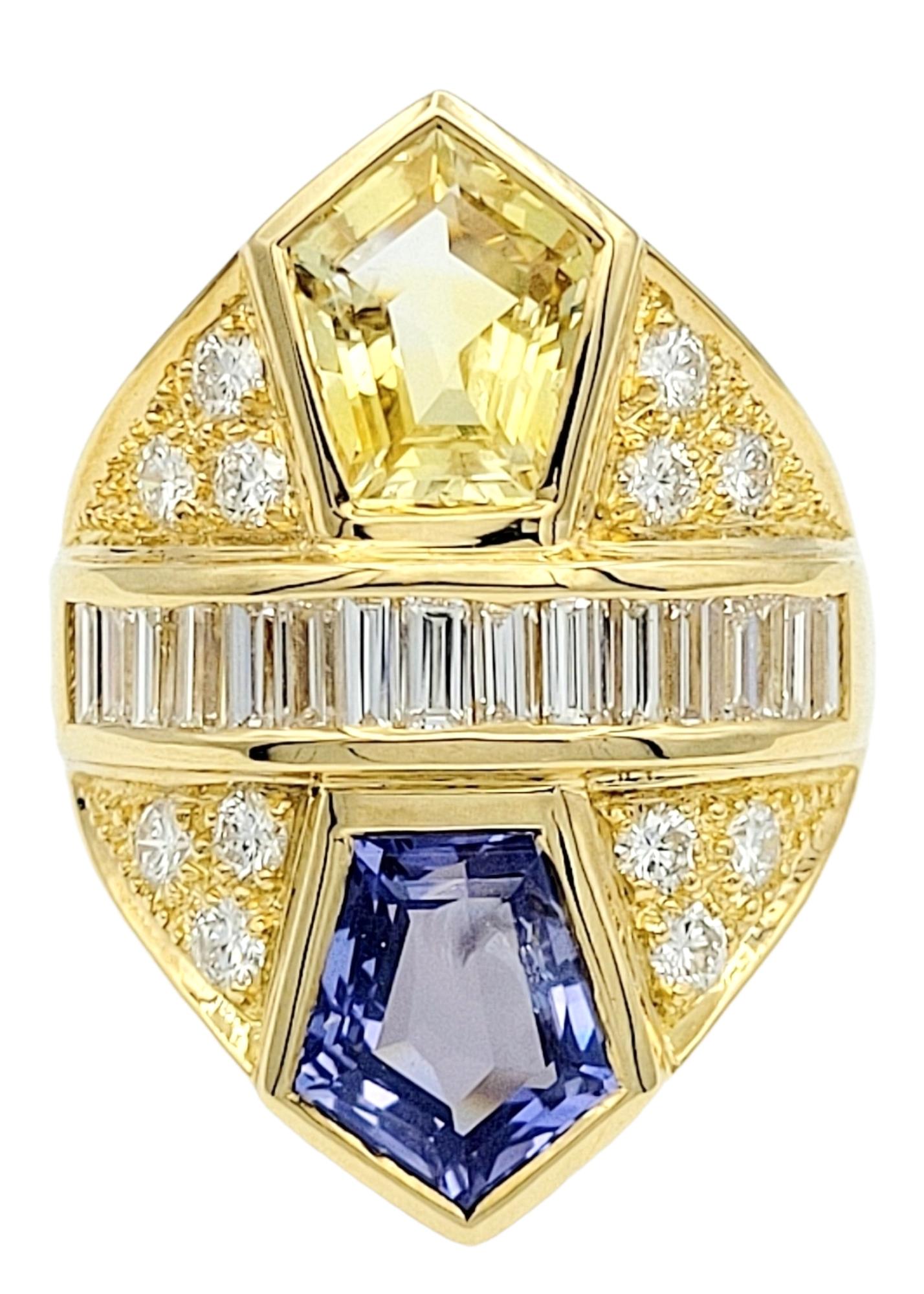 Ring Size: 6.75

An exquisitely designed cocktail ring of unparalleled beauty! This remarkable piece showcases the brilliance of natural sapphires and diamonds set in 18-karat yellow gold.

The centerpiece features two large pentagon-cut natural