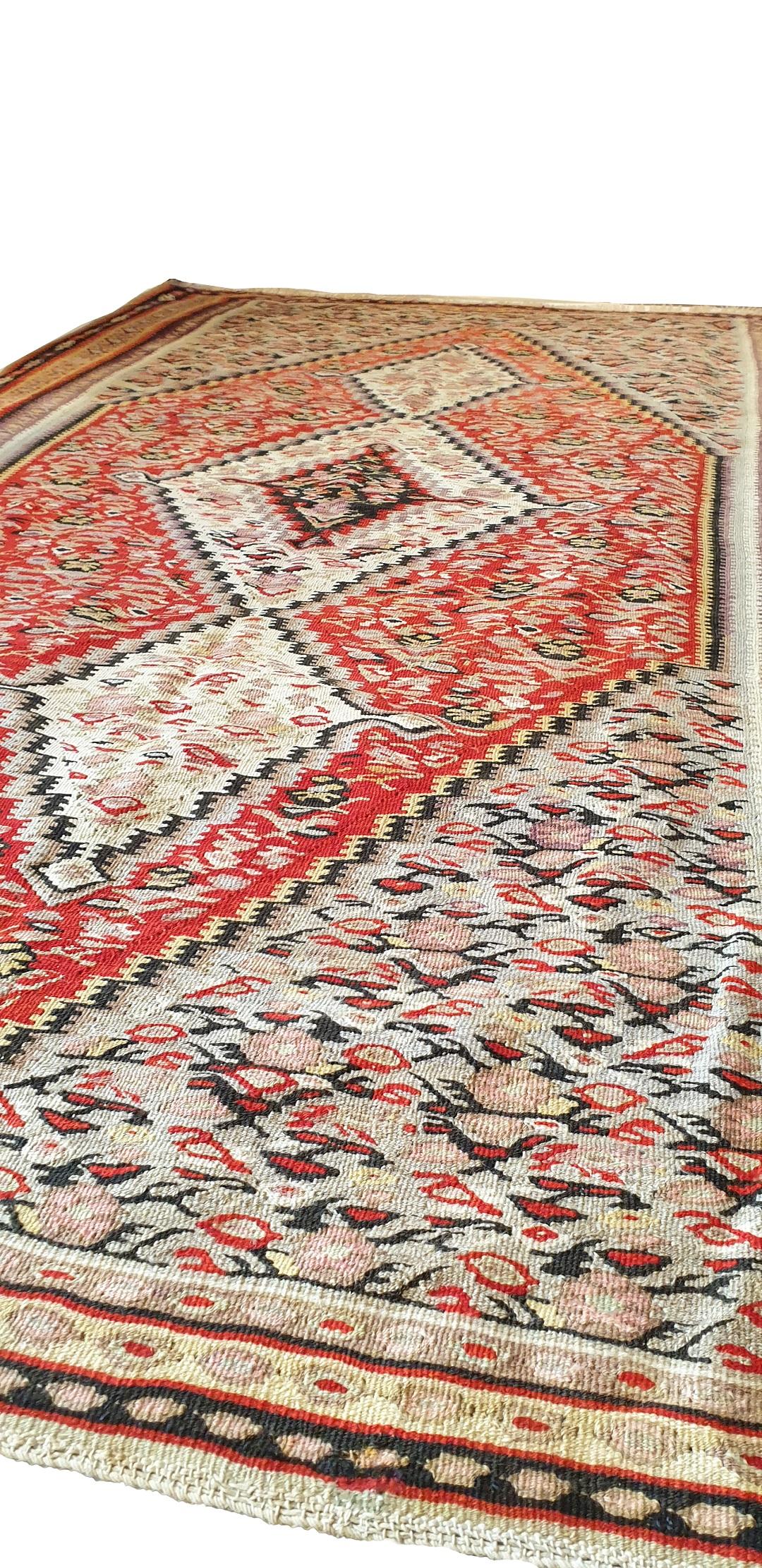 664 - Nice kilim from the end of the 19th century with beautiful fine central medallion patterns, and beautiful pink, orange, yellow, green and dark brown colors, entirely hand-woven with wool woven on a cotton foundation.