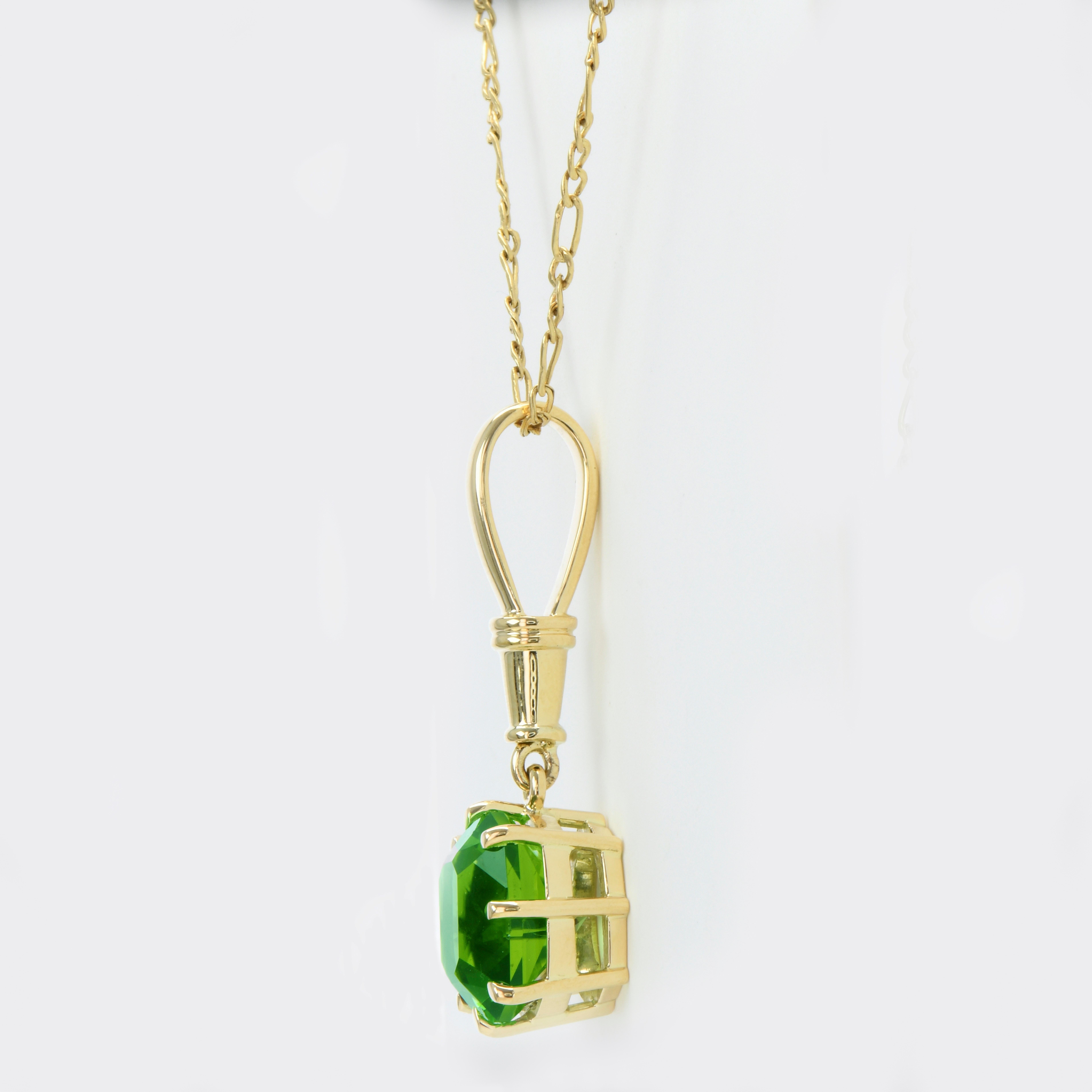 Green Tourmaline Pendant
Creator: Carson Gray Jewels
Ring Size: N/A
Metal: 18KT
Stone: Green Tourmaline
Stone Cut: Barion Mixed Step
Weight: 6.64
Style: Pendant
Place of Origin: Congo 
Period: Modern
Date of Manufacture (circa): November 2023