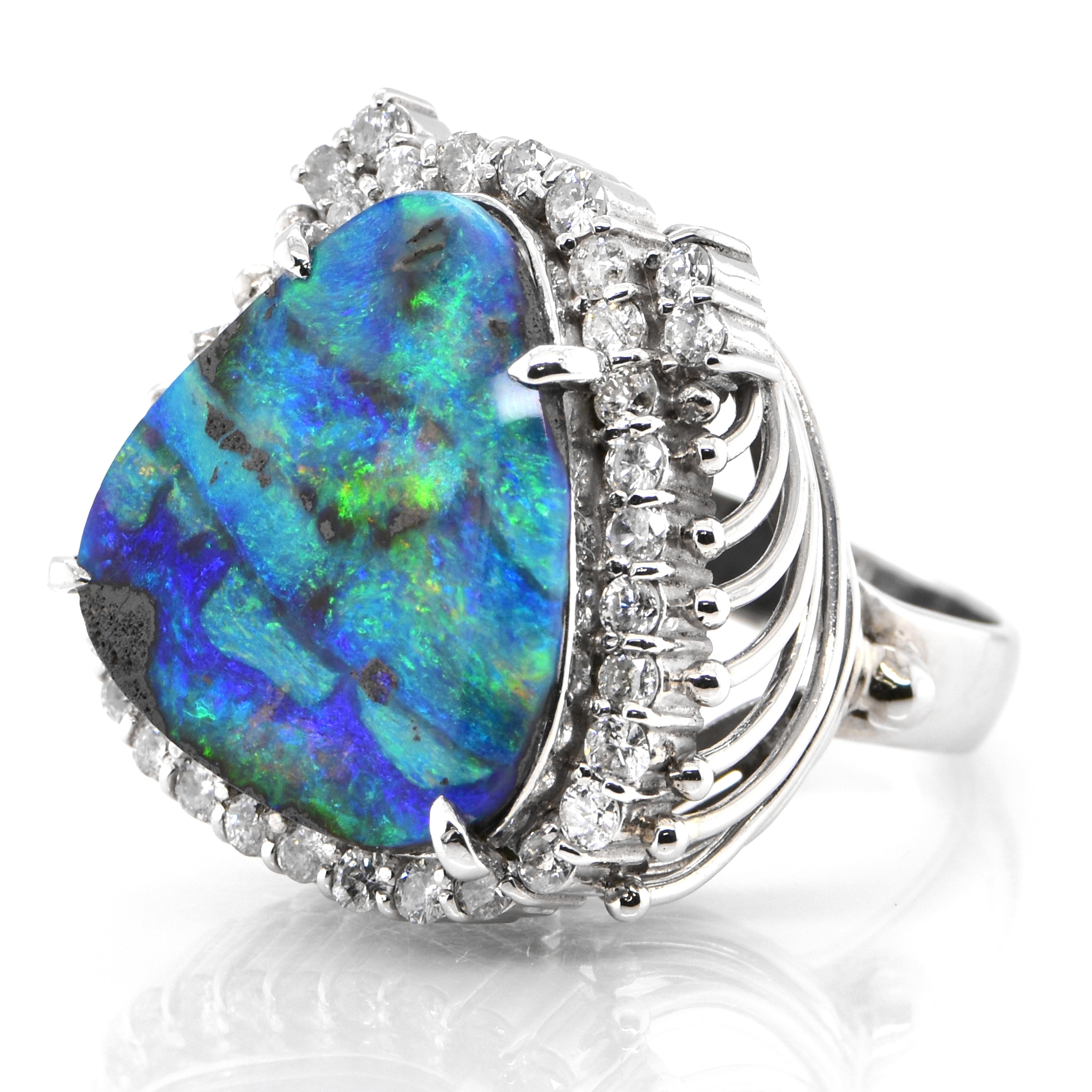 A beautiful ring featuring a 6.66 Carat, Natural, Australian Boulder Opal and 0.86 Carats of Diamond Accents set in Platinum. The Opal displays very good play of color! Opals are known for exhibiting flashes of rainbow colors known as 